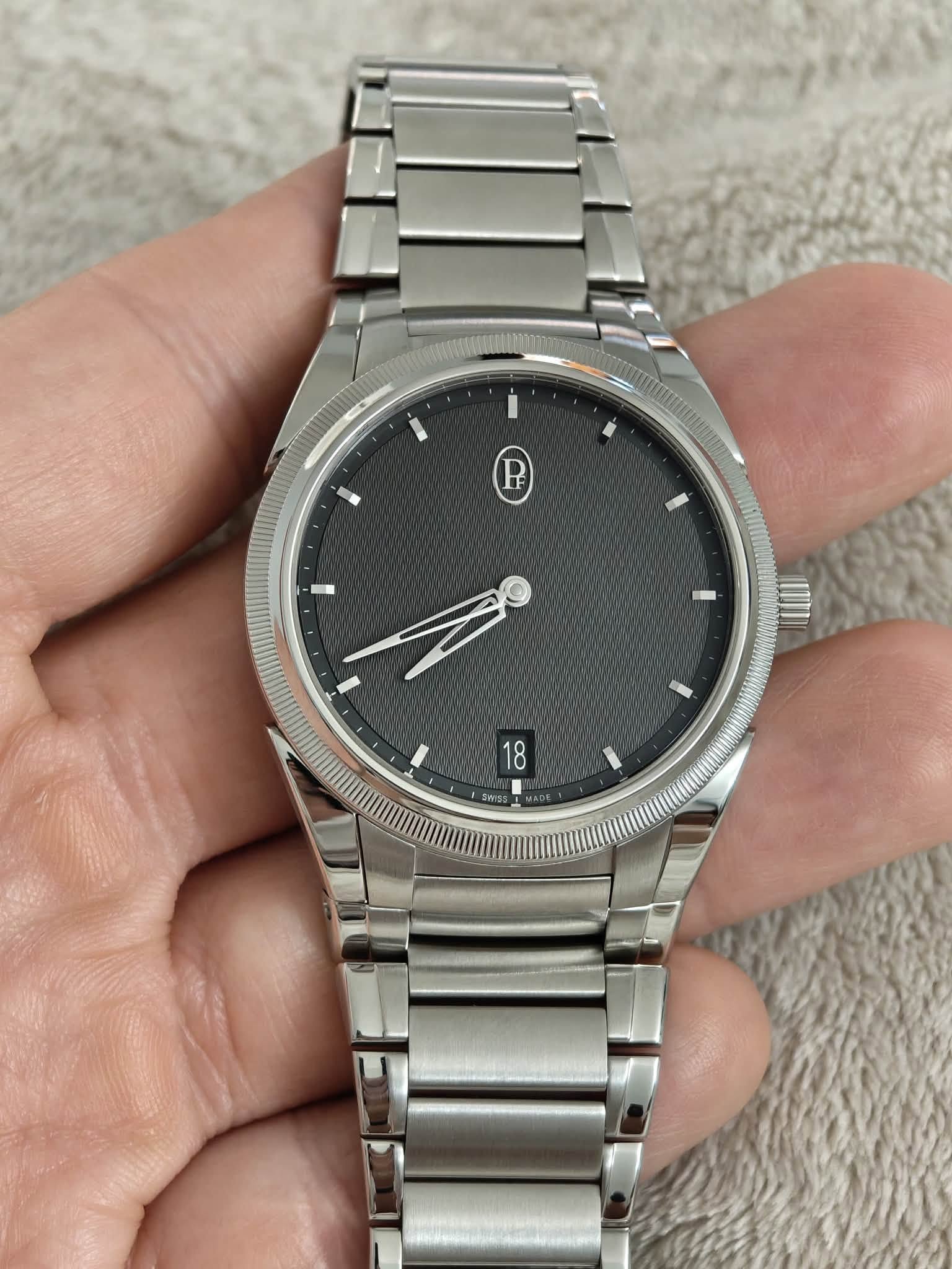 May be an image of wrist watch and text