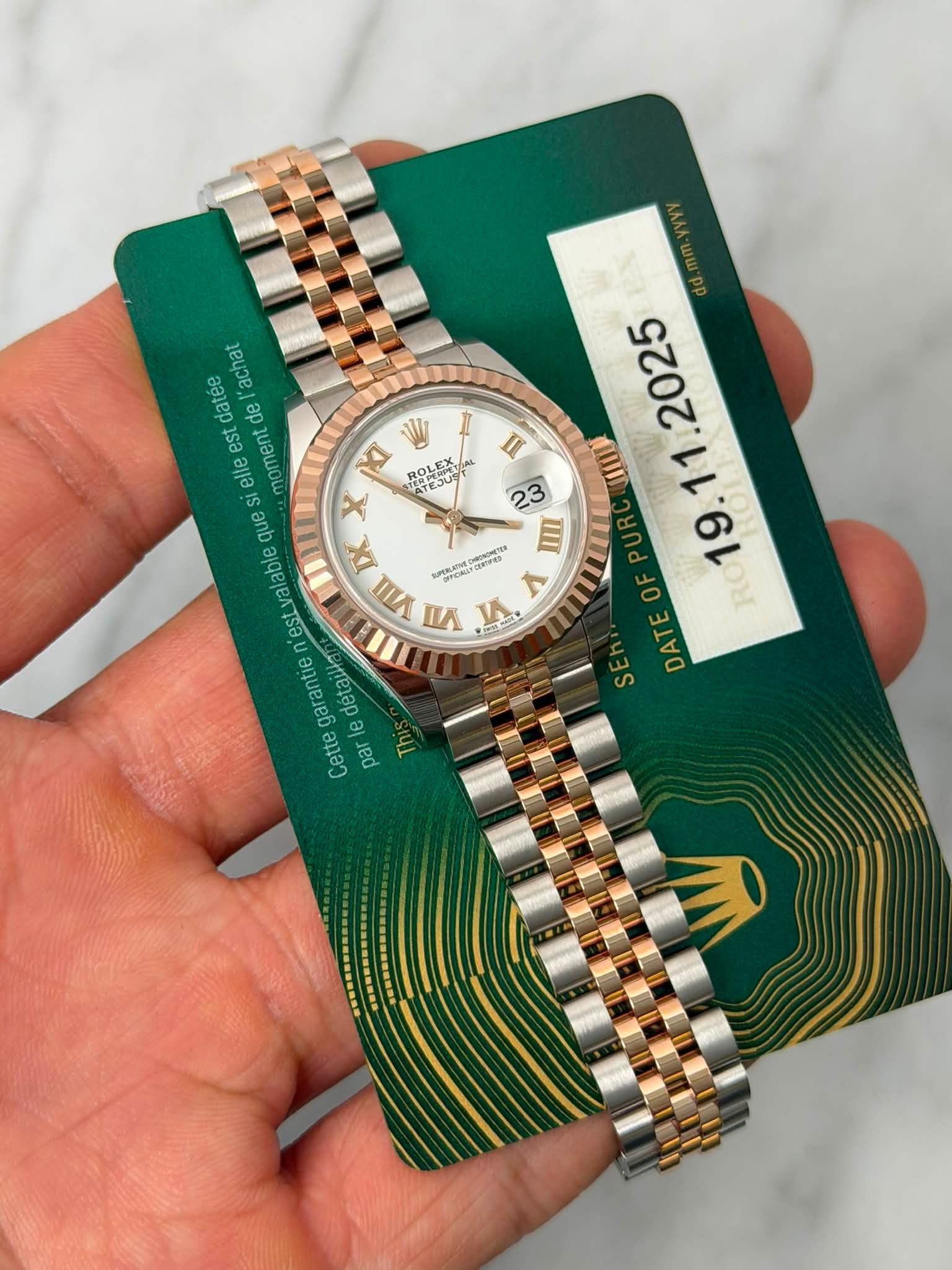 May be an image of wrist watch and text that says '1 U datee de 'achat est elle moment que lable est garantie Cette par κι ROLEX ်ယရ س X EX VII pAaи 0 O . E ム E DATE RO'