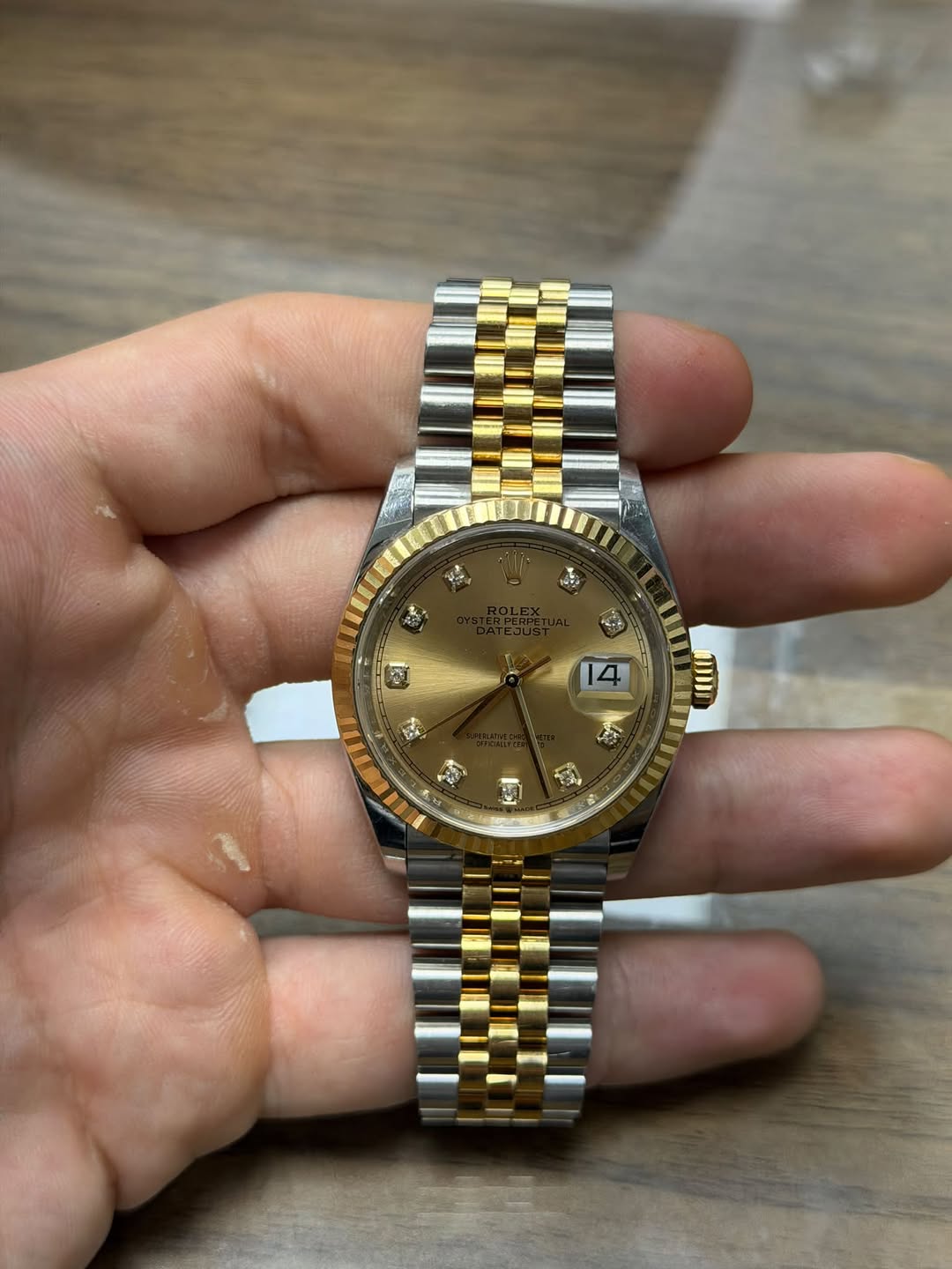 May be an image of wrist watch and text