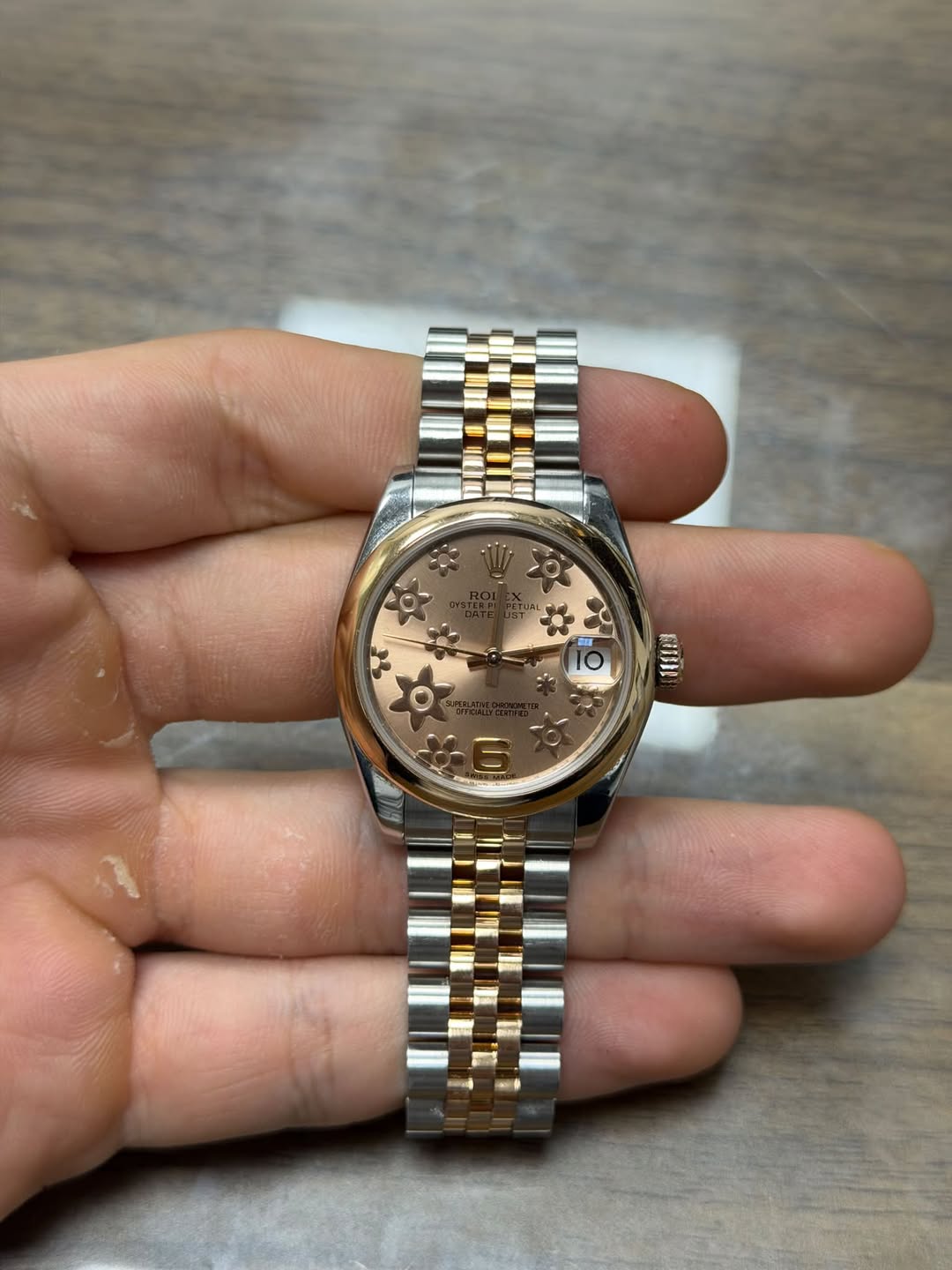 May be an image of wrist watch and text