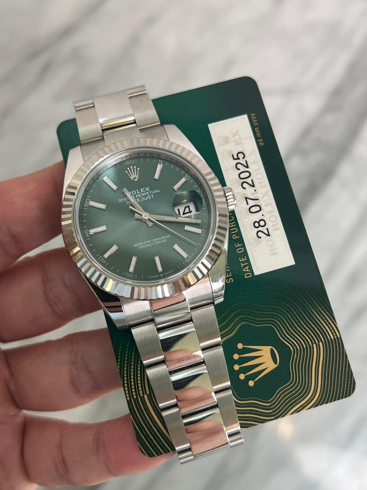 May be an image of wrist watch and text