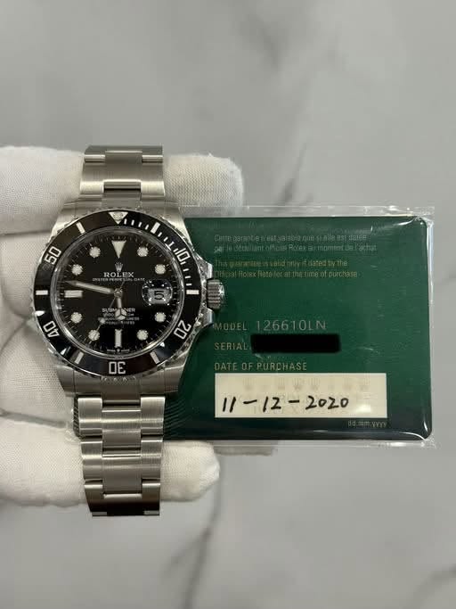 May be an image of wrist watch and text that says '50 ROLEX I 10 40 2 ΟΕ I1 2020'