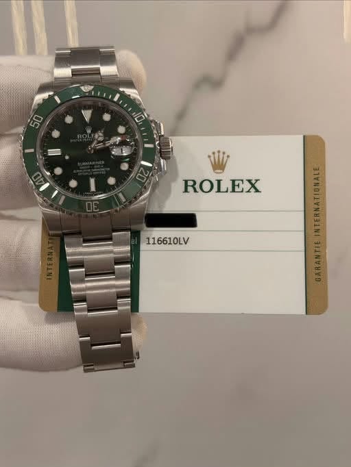 May be an image of wrist watch and text that says 'LO ROLEX 116610LV AN'