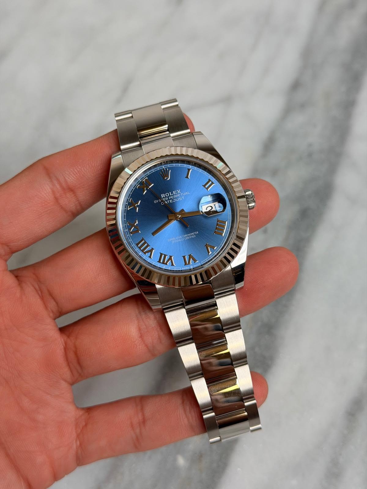 May be an image of wrist watch and text