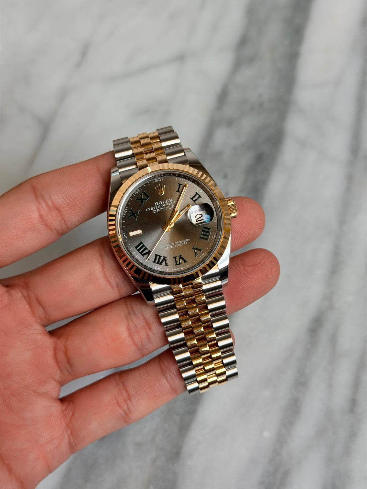 May be an image of wrist watch and text