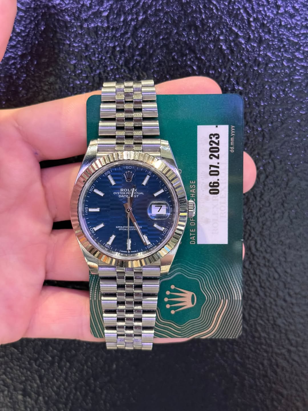 May be an image of wrist watch and text that says '60 Se WSTERFE TEREC ROLI SUAL CTLAL DATEL 45 AAVA d.mm.yyyy mm dd UCHASE HASE 06. OF ROLEX DATE 남날 7 22 M'