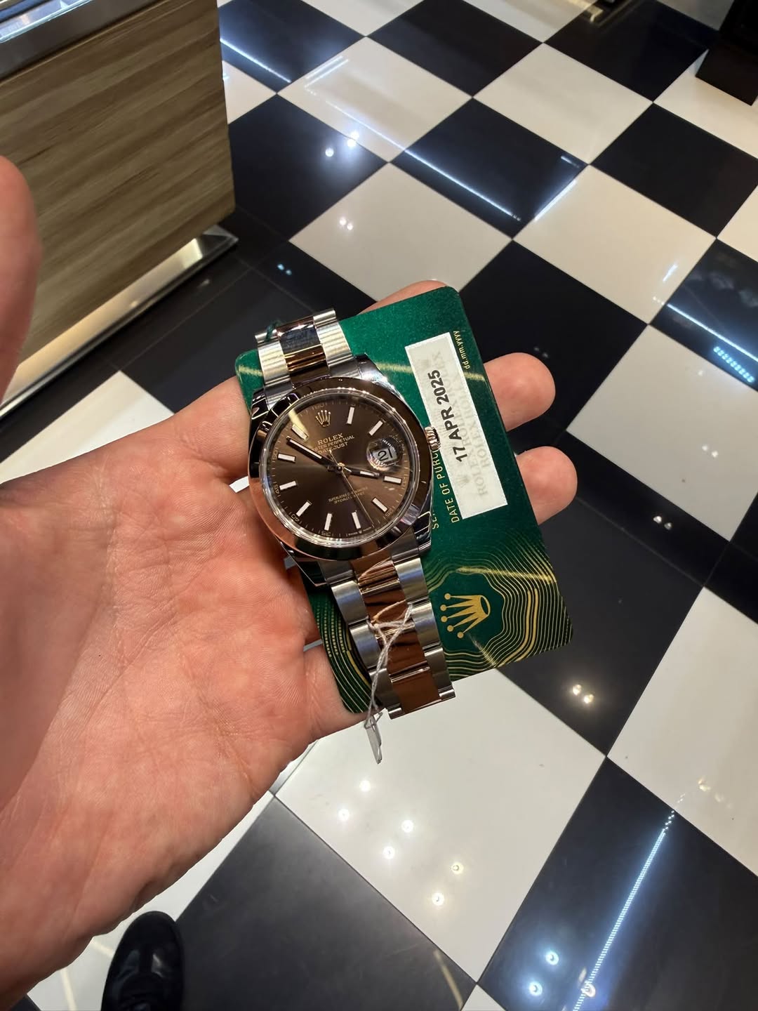 May be an image of wrist watch and text