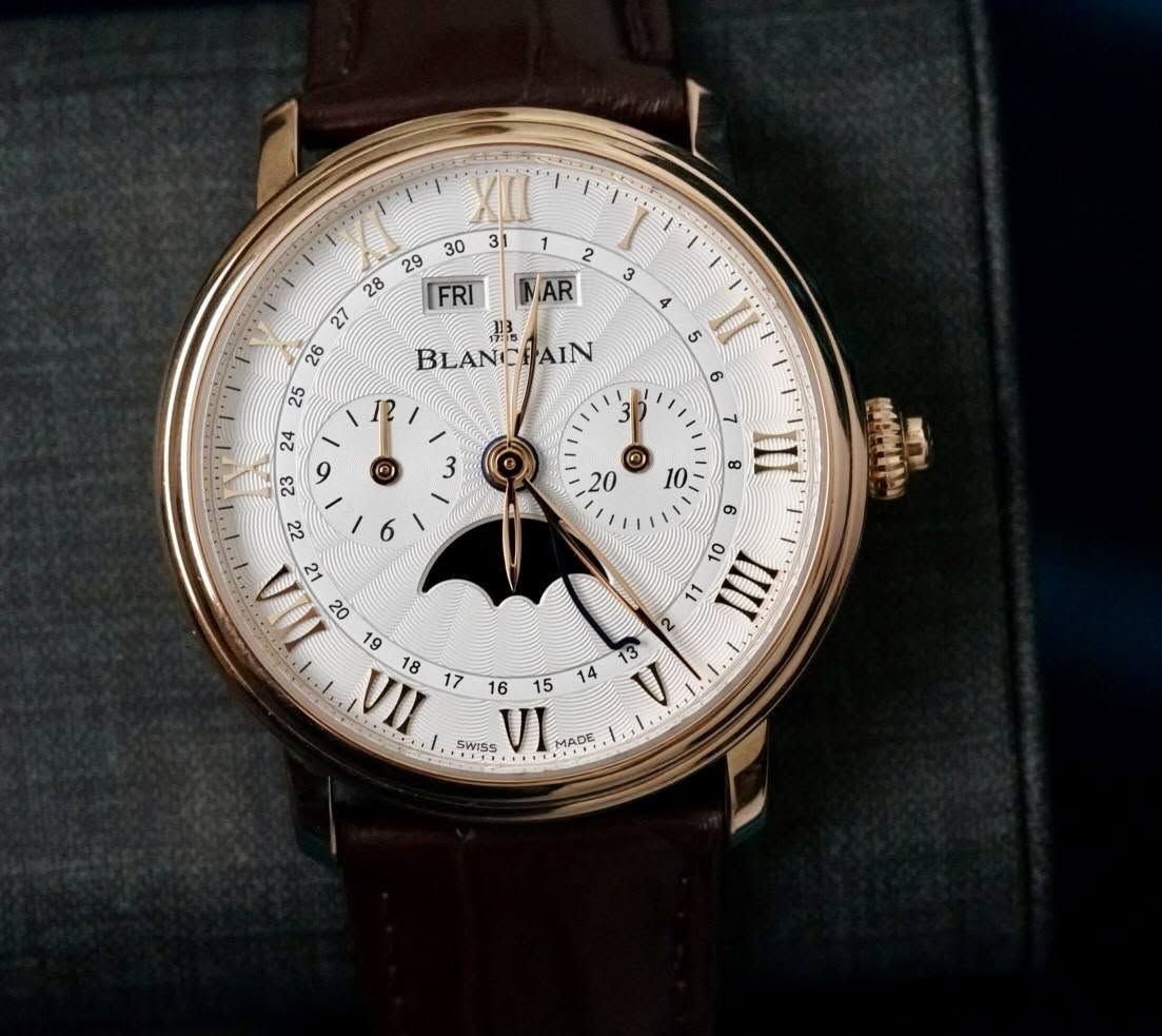 May be an image of ‎wrist watch and ‎text that says '‎1 2 NAR XL FRI 27 ه 26 BLANCHAIN AIN e م I 16 15 SWISS VI A‎'‎‎