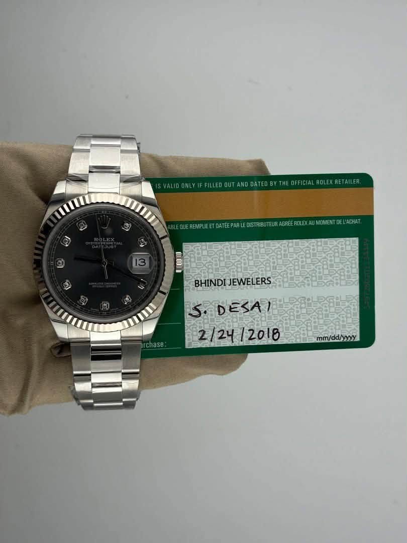 May be an image of wrist watch and text that says 'WYFELEOTLOOEEE YTHEOFFICIAL EREMPLIEE EROLEXAL MOMENT L'ACHAT. 13 0 BHINDI BHINDIJEWELERS JEWELERS rchase: S.DESAI 2/24 2/24/2018…