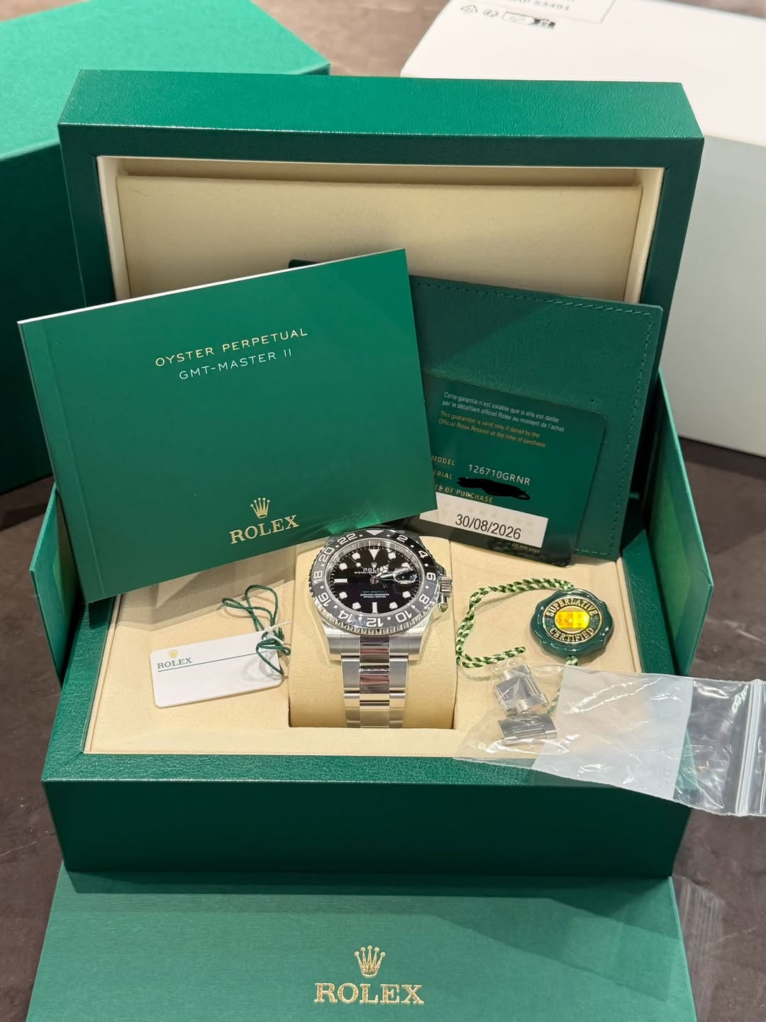 May be an image of wrist watch and text that says '冰 ピスジク OYSTERPERPETUAL TUAL OYSTER GMT-MASTER PERPETUAL 11 ม่ Wis ROLEX RO 12G710GANR 한한 30/08/2026 ២ E- ወ. S 2L O OV L MMTL…