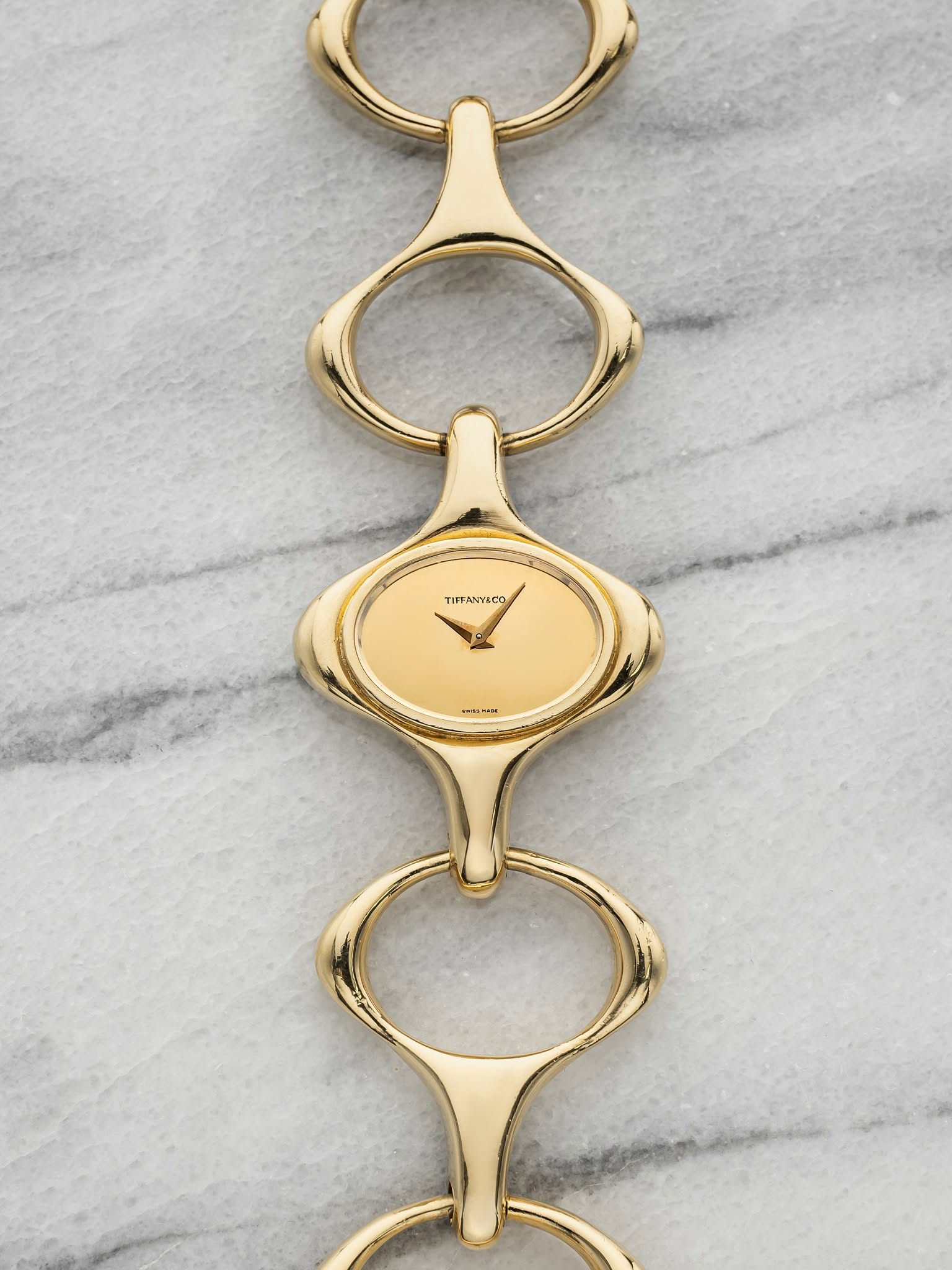 May be an image of brass, jewelry and text