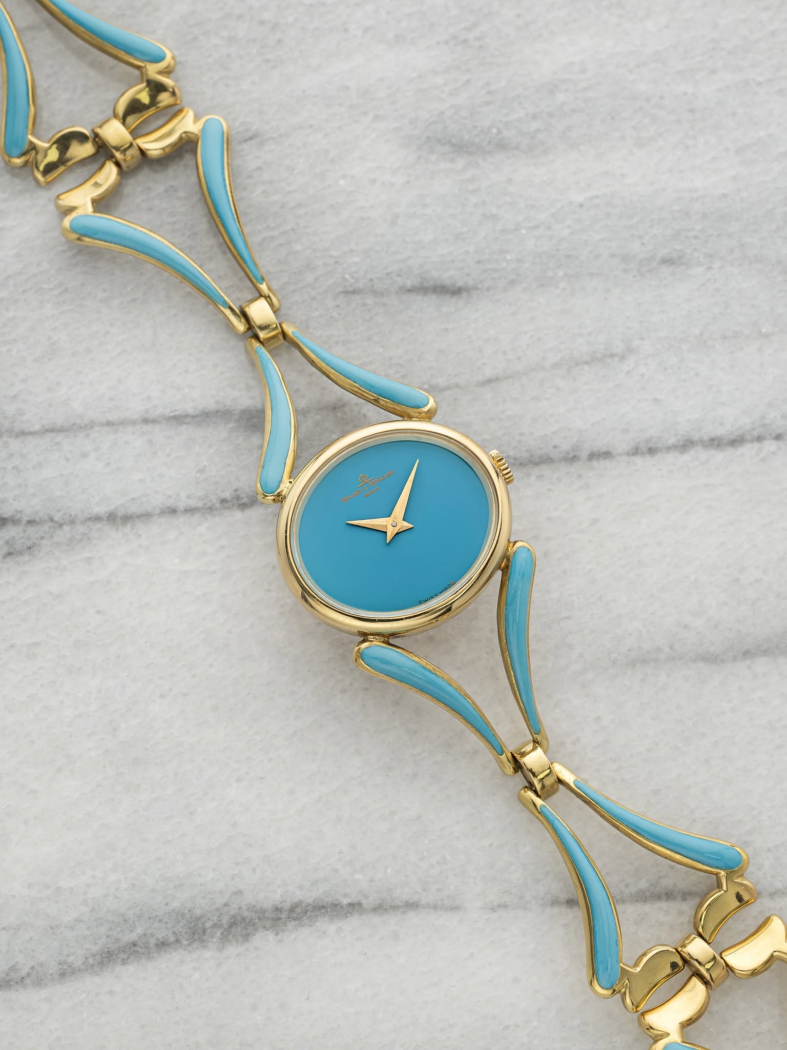 May be an image of jewelry, wrist watch and text