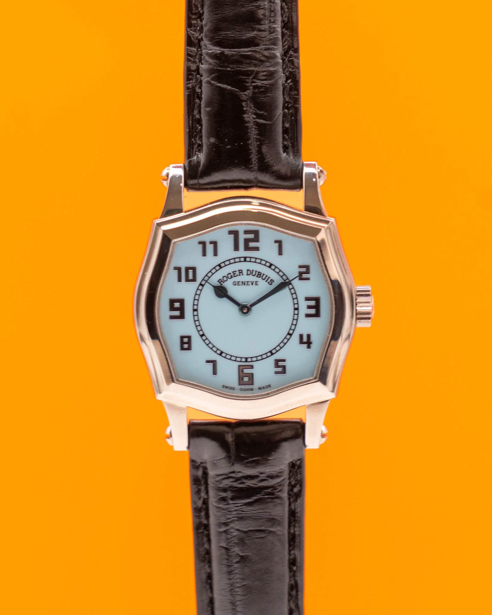May be an image of wrist watch, leather and text