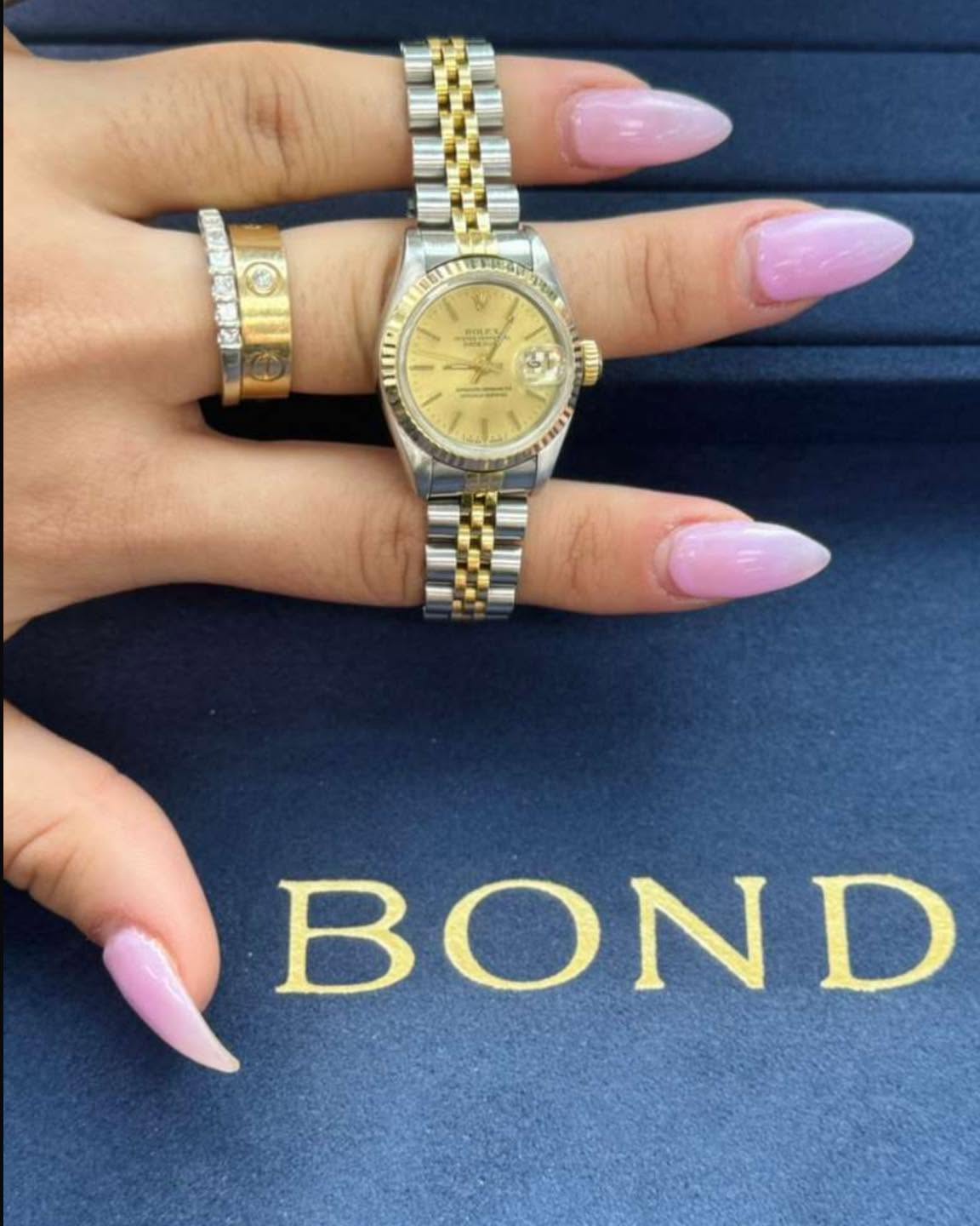 May be an image of ring, wrist watch and text
