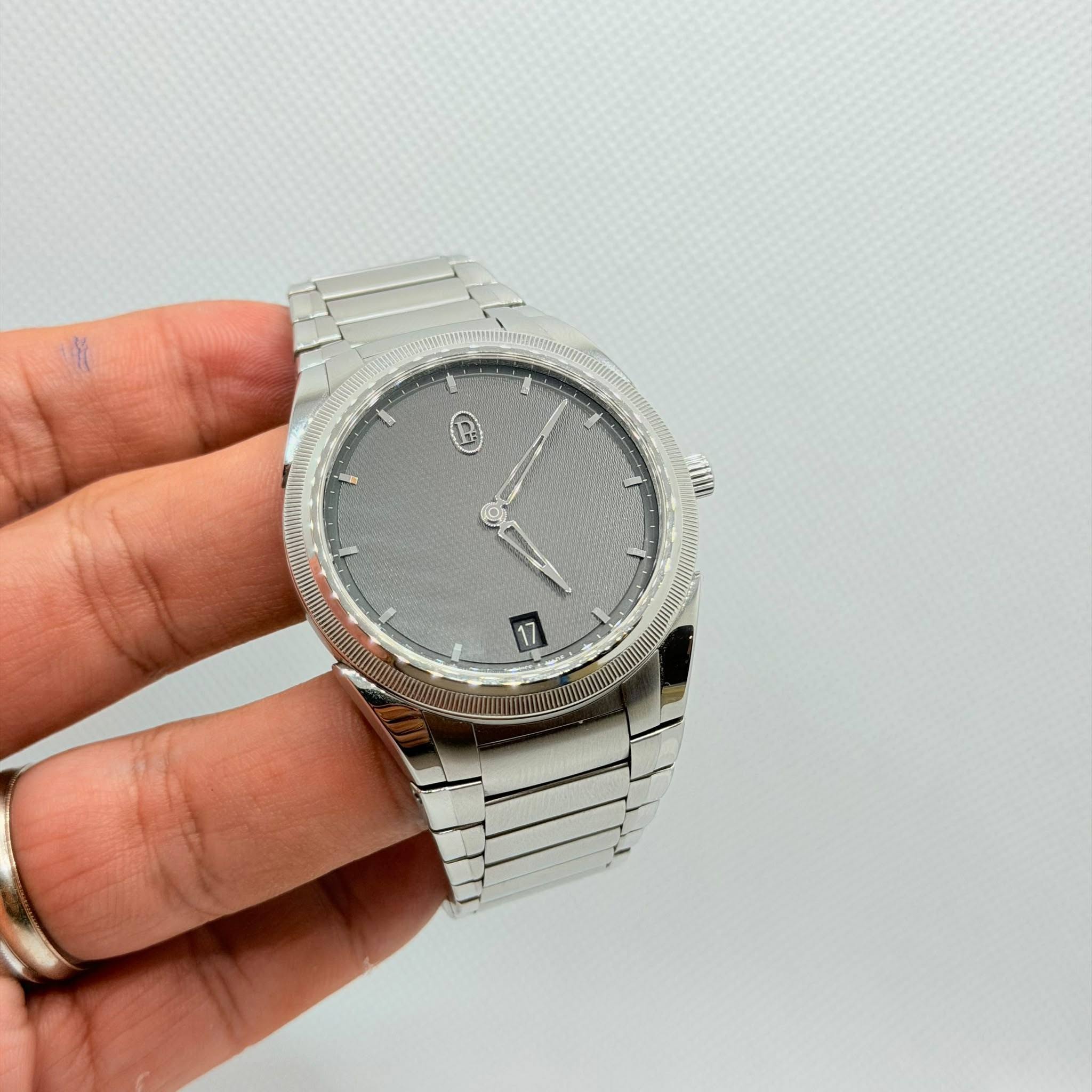May be an image of wrist watch and text
