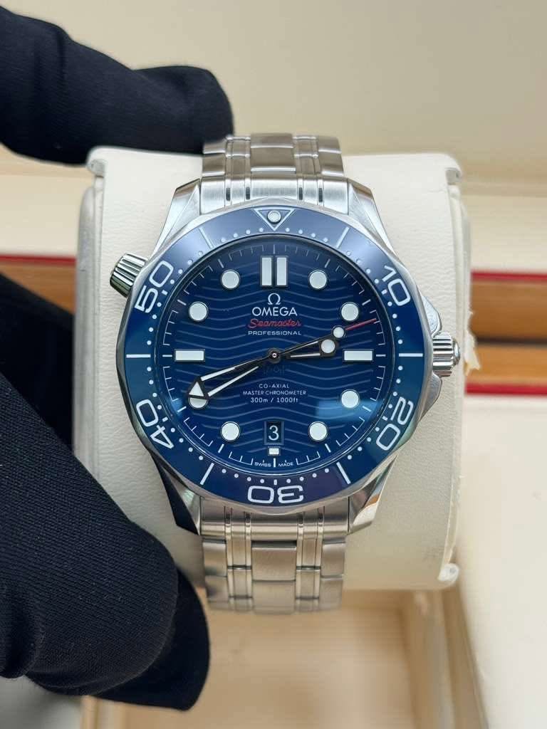 May be an image of wrist watch and text that says '50 0 5 OMEGA GA PROFESSIONAL SIC 10 AXIAL 300m 1000ft ගු. ب 0 បលិល MADE'