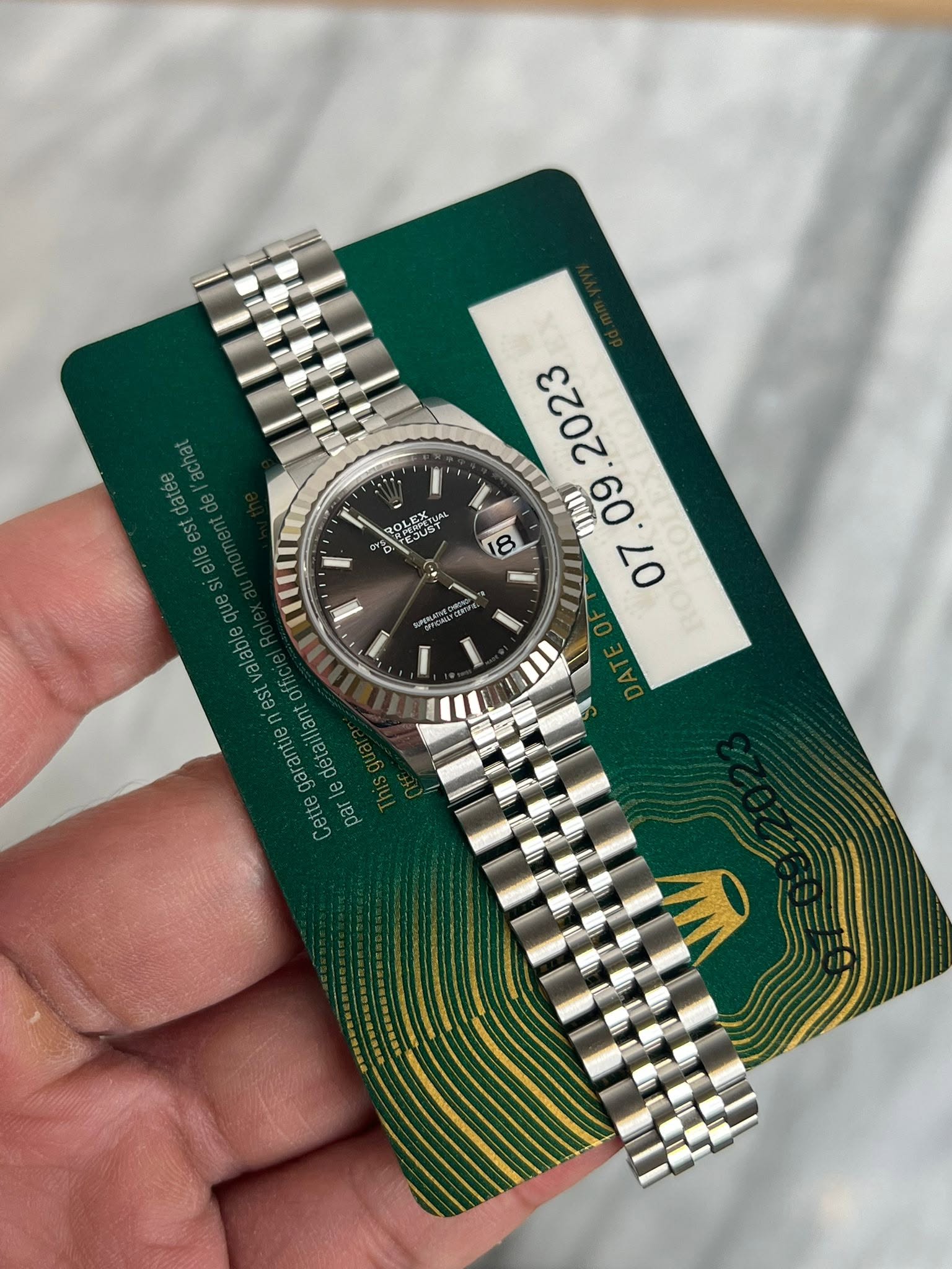 May be an image of wrist watch and text