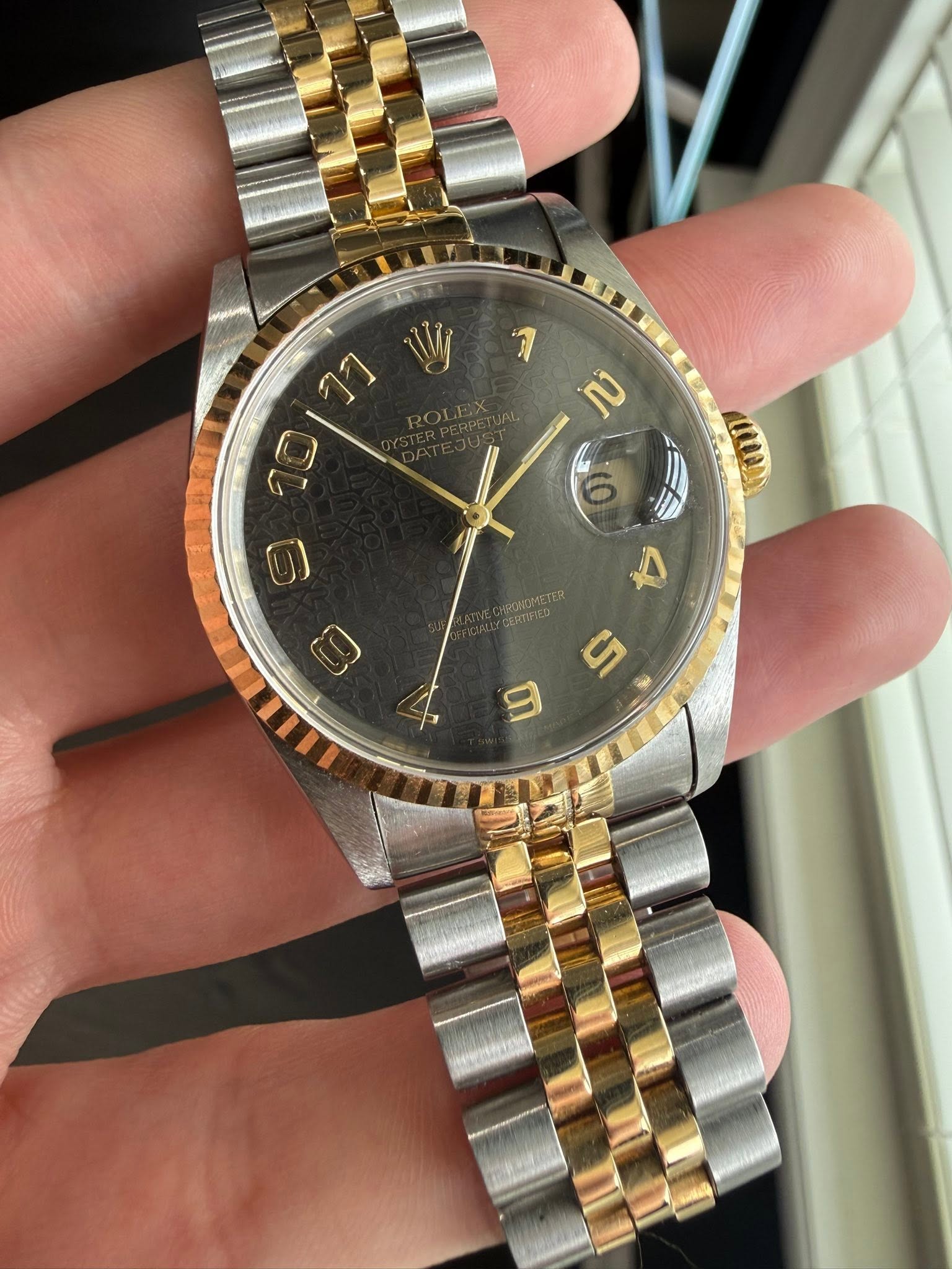 May be an image of wrist watch and text