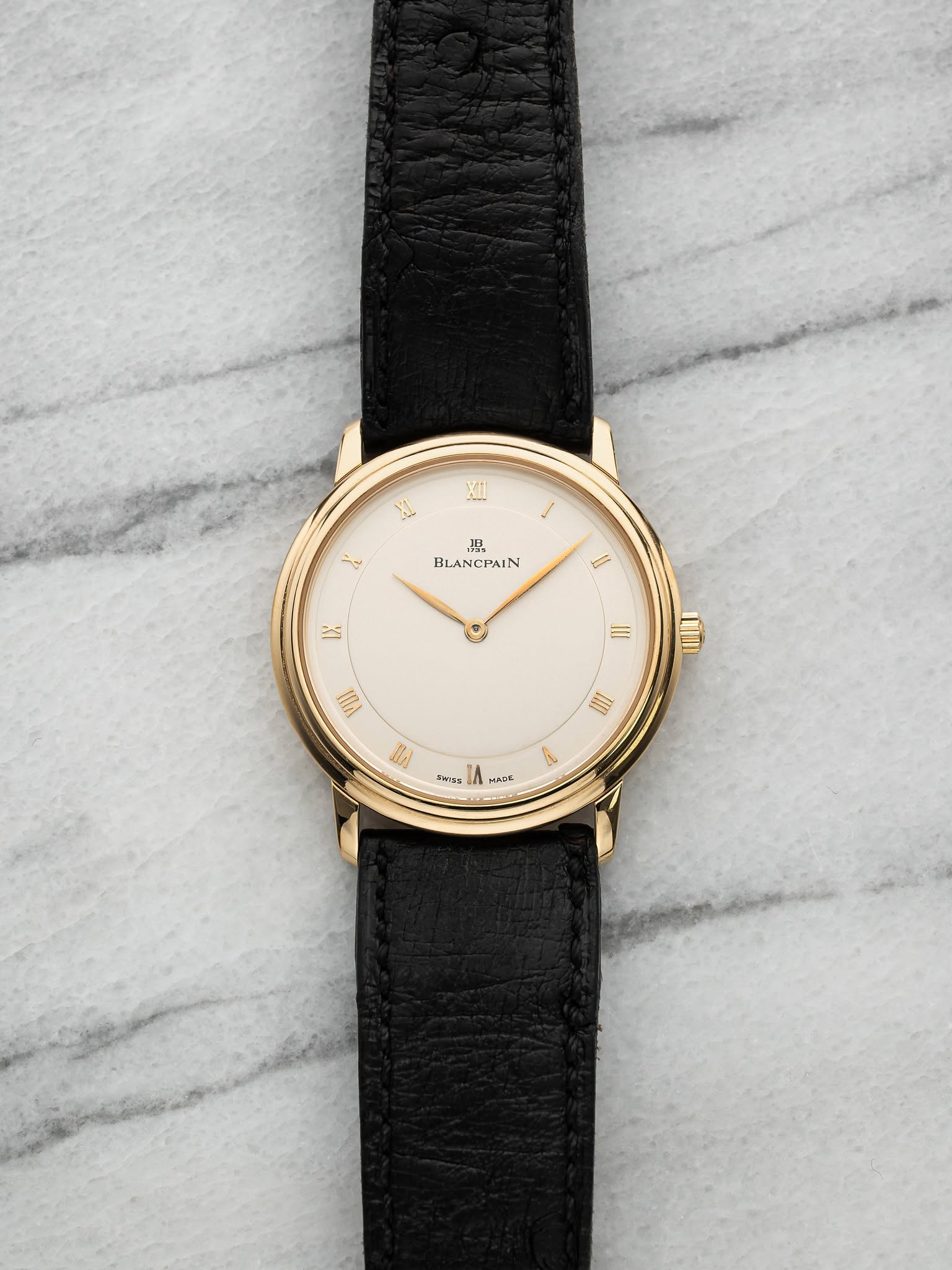 May be an image of leather, wrist watch and text