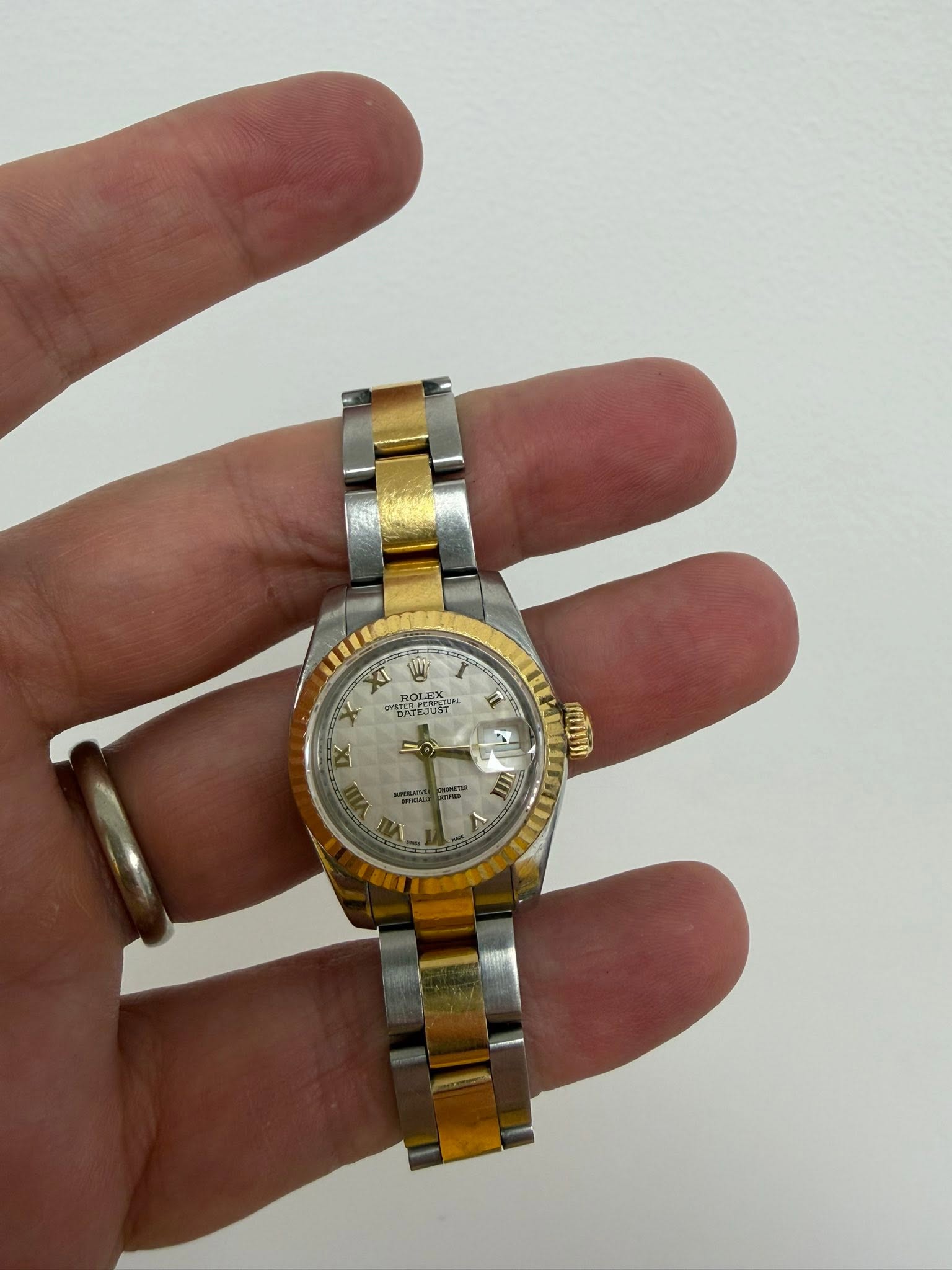 May be an image of wrist watch and text