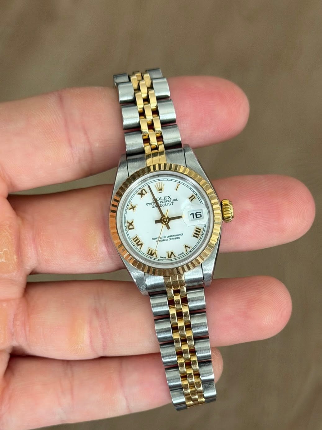May be an image of wrist watch and text