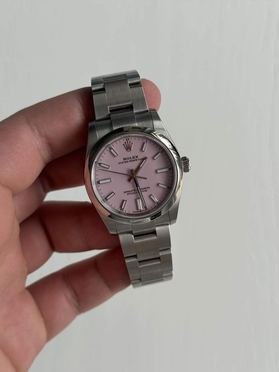 May be an image of wrist watch and text