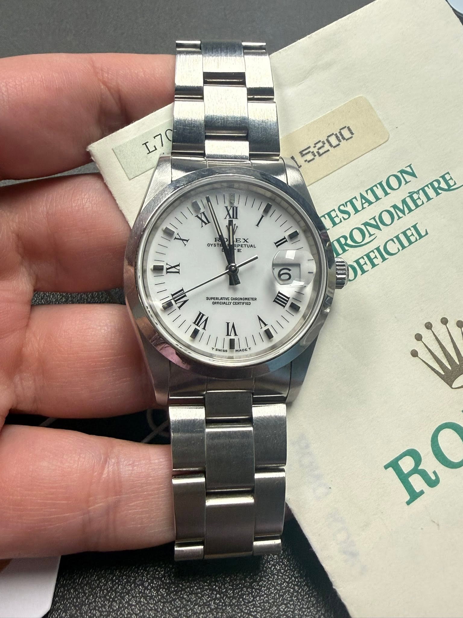 May be an image of wrist watch and text