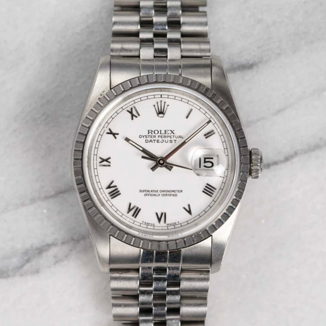 May be an image of wrist watch and text