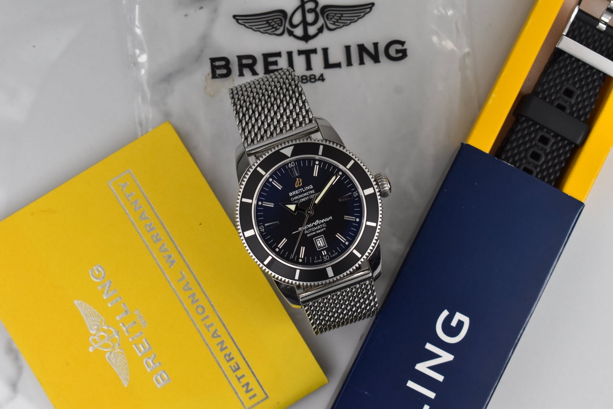 May be an image of wrist watch and text that says 'BREITLING Il 60 ii' ING BRE vrdoeart 1 37 11 ALNKENVM () อา ING'