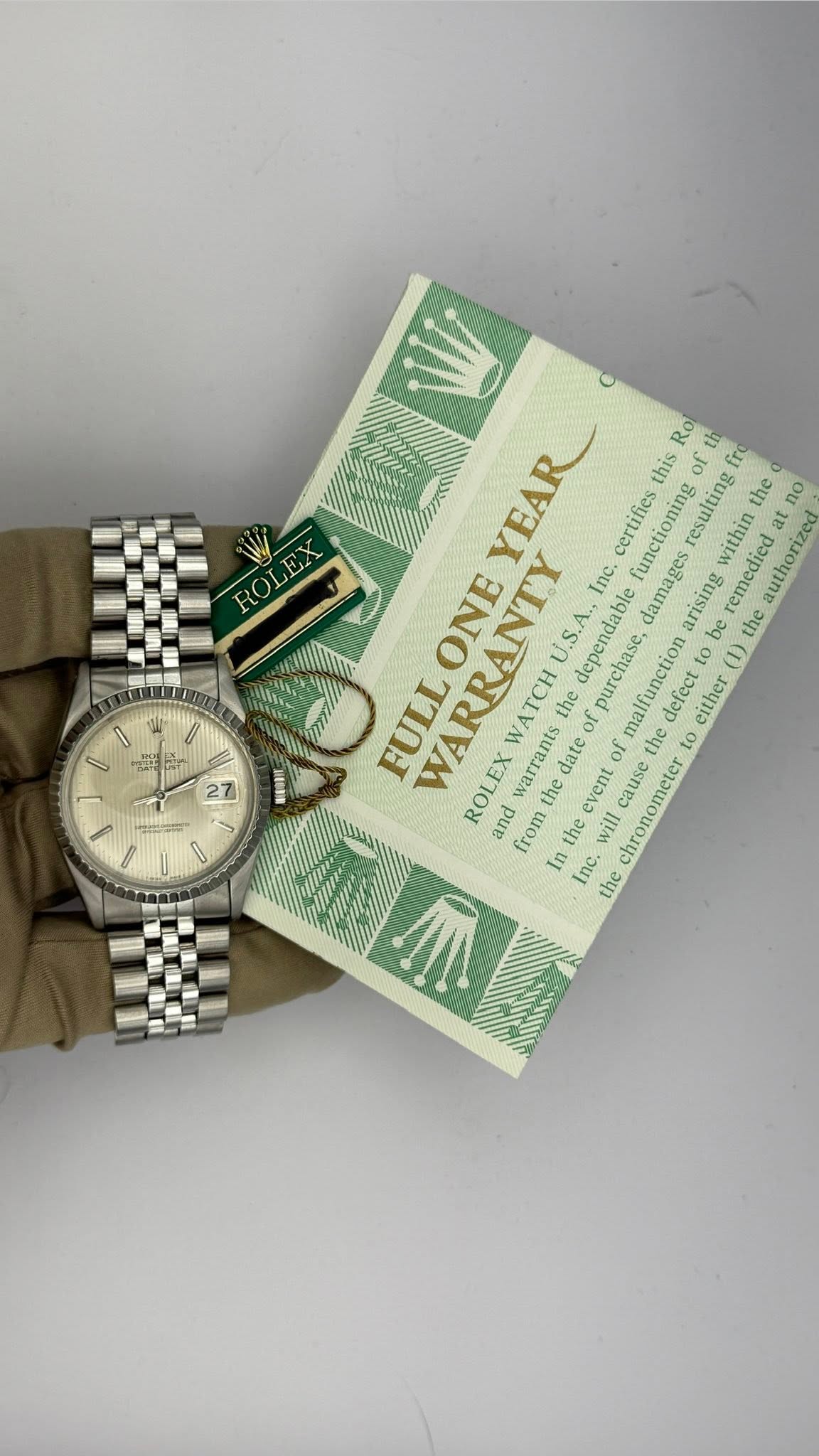 May be an image of wrist watch and text that says 'ΠΟυώε IT YEAR certifies resulting Rol this of functioning remedied the the at no within Inc. amages arising be authorized at…