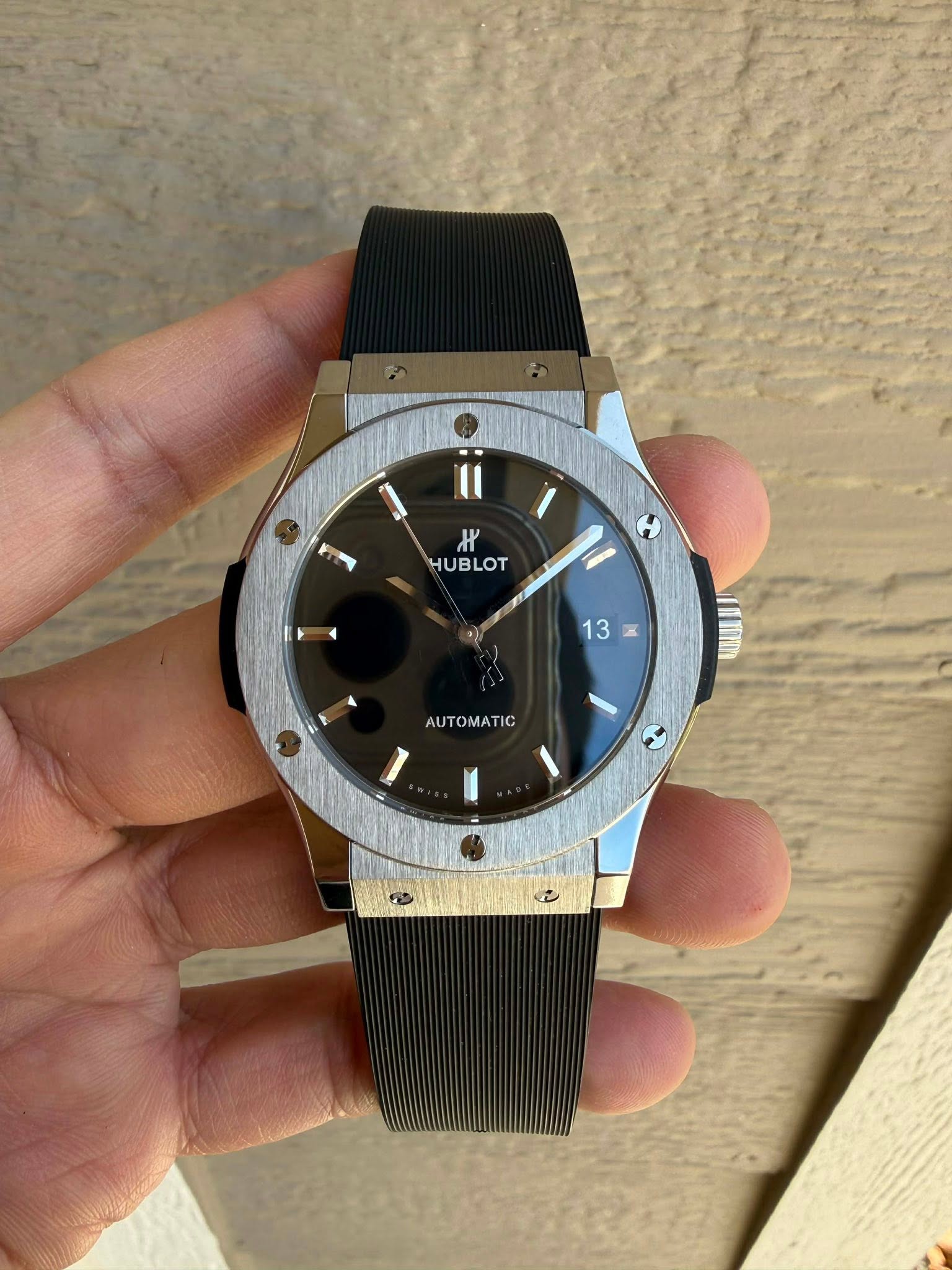 May be an image of wrist watch and text that says 'H HUBLOT HUBLOT ١ 13 K a 13 AUTOMATIC'
