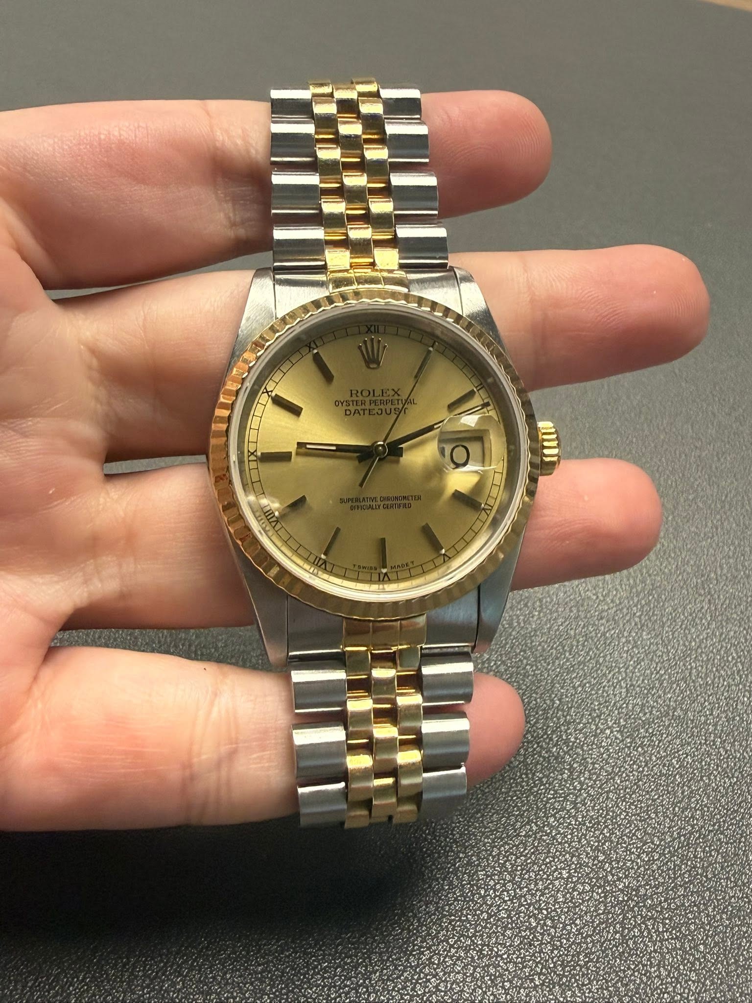 May be an image of wrist watch and text
