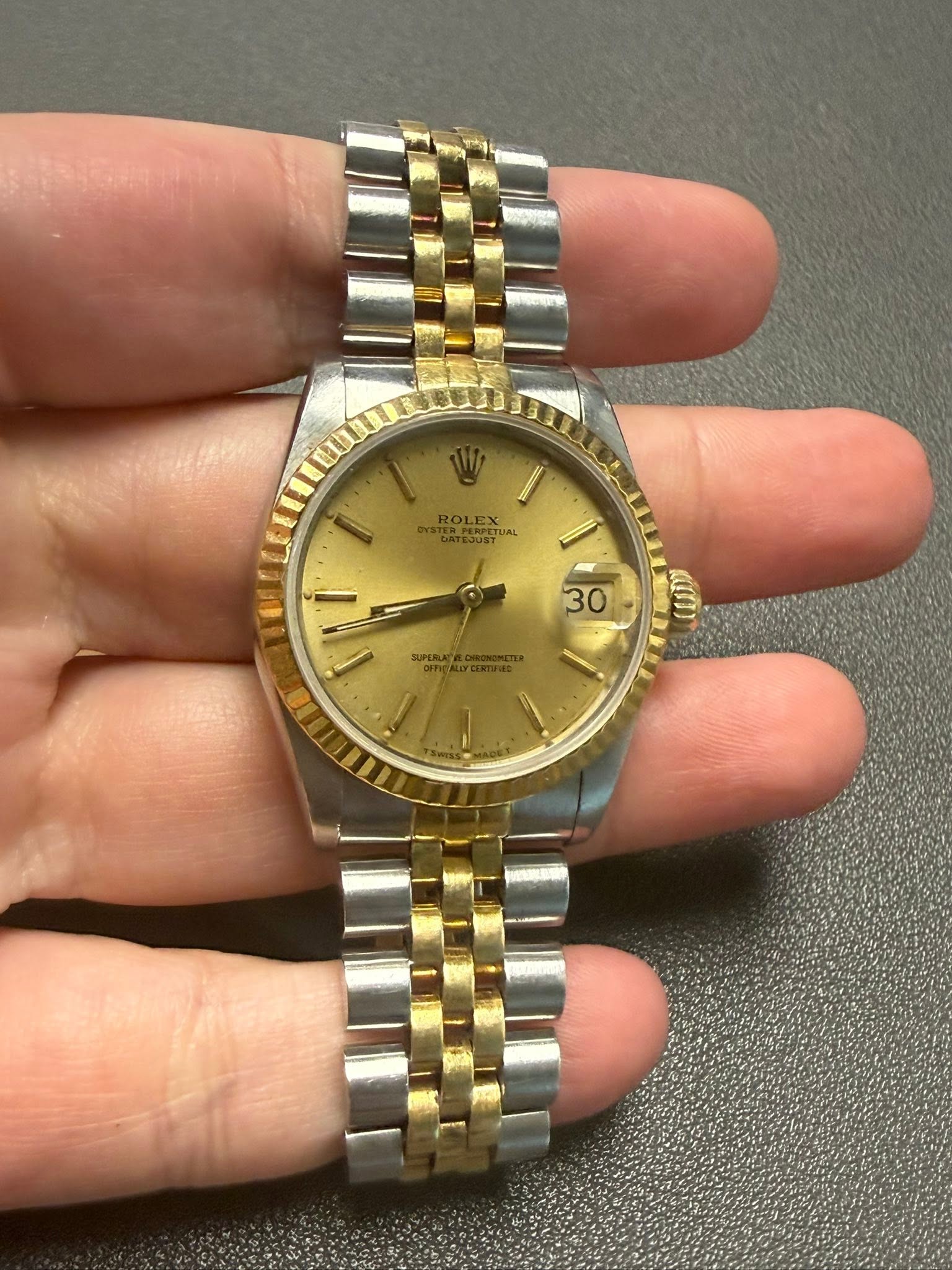 May be an image of wrist watch and text