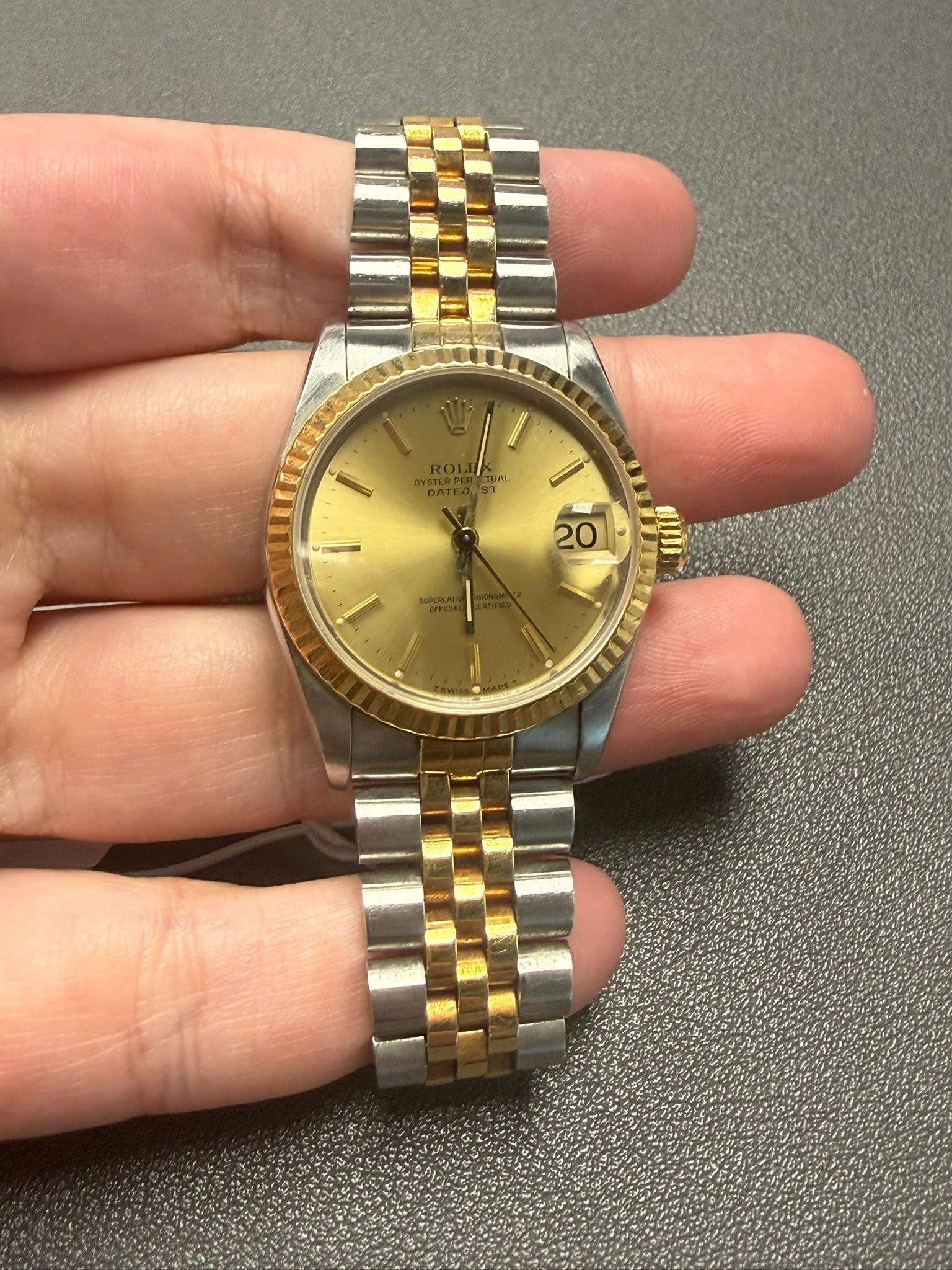 May be an image of wrist watch and text