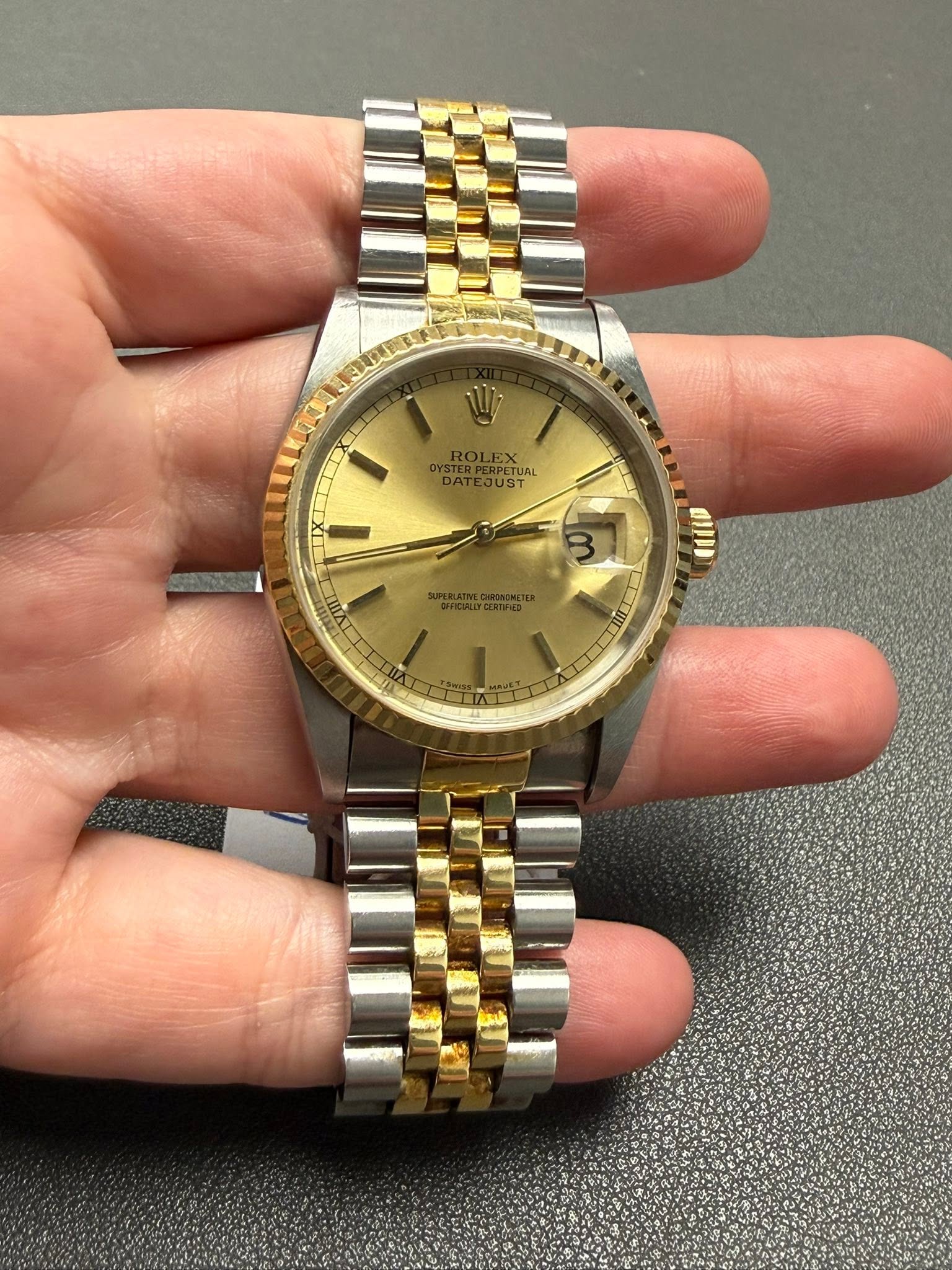 May be an image of wrist watch and text