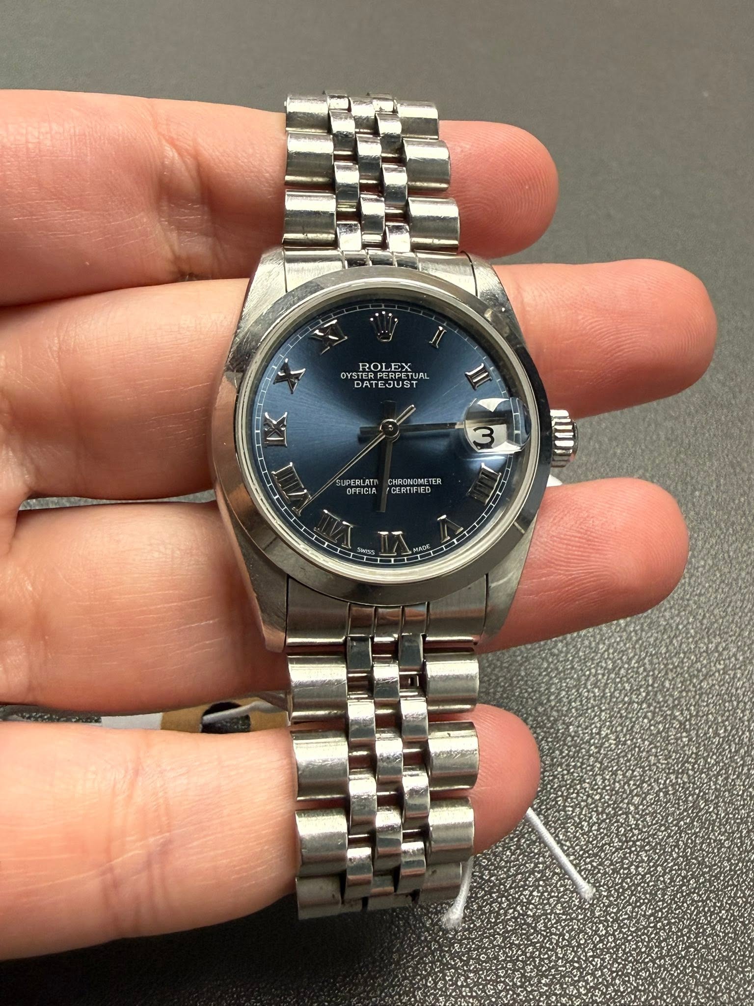 May be an image of wrist watch and text
