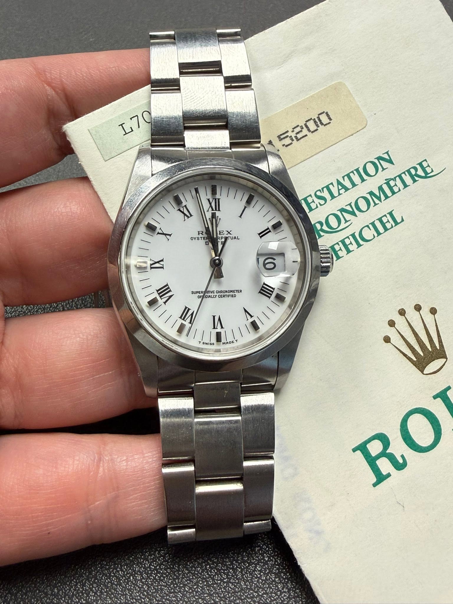 May be an image of wrist watch and text