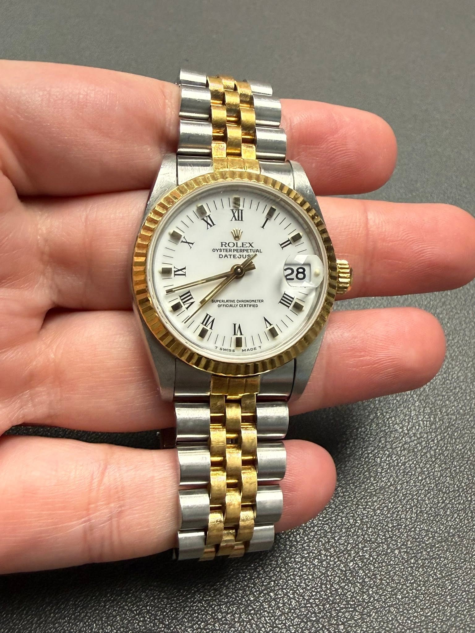May be an image of wrist watch and text
