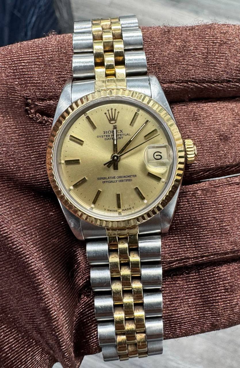 May be an image of wrist watch and text