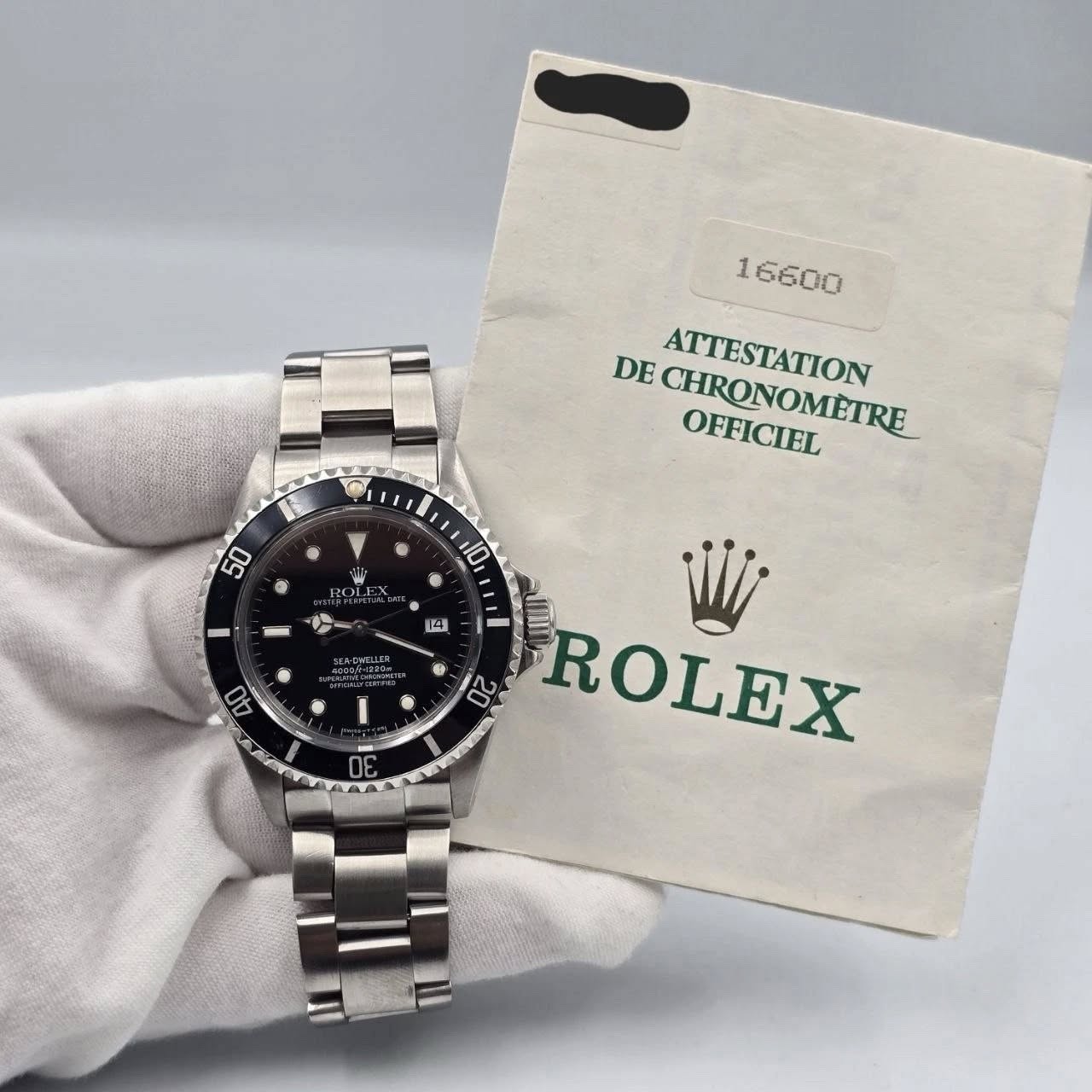 May be an image of wrist watch and text that says '1 16600 DE CHRONOMFIRE CHRONOMETRE OFFICIEL ATTESTATION S 50 10 R ROLI 份 14 AD - ن ROLEX 02'