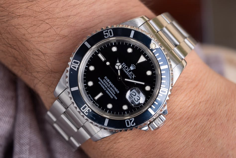 May be an image of wrist watch and text