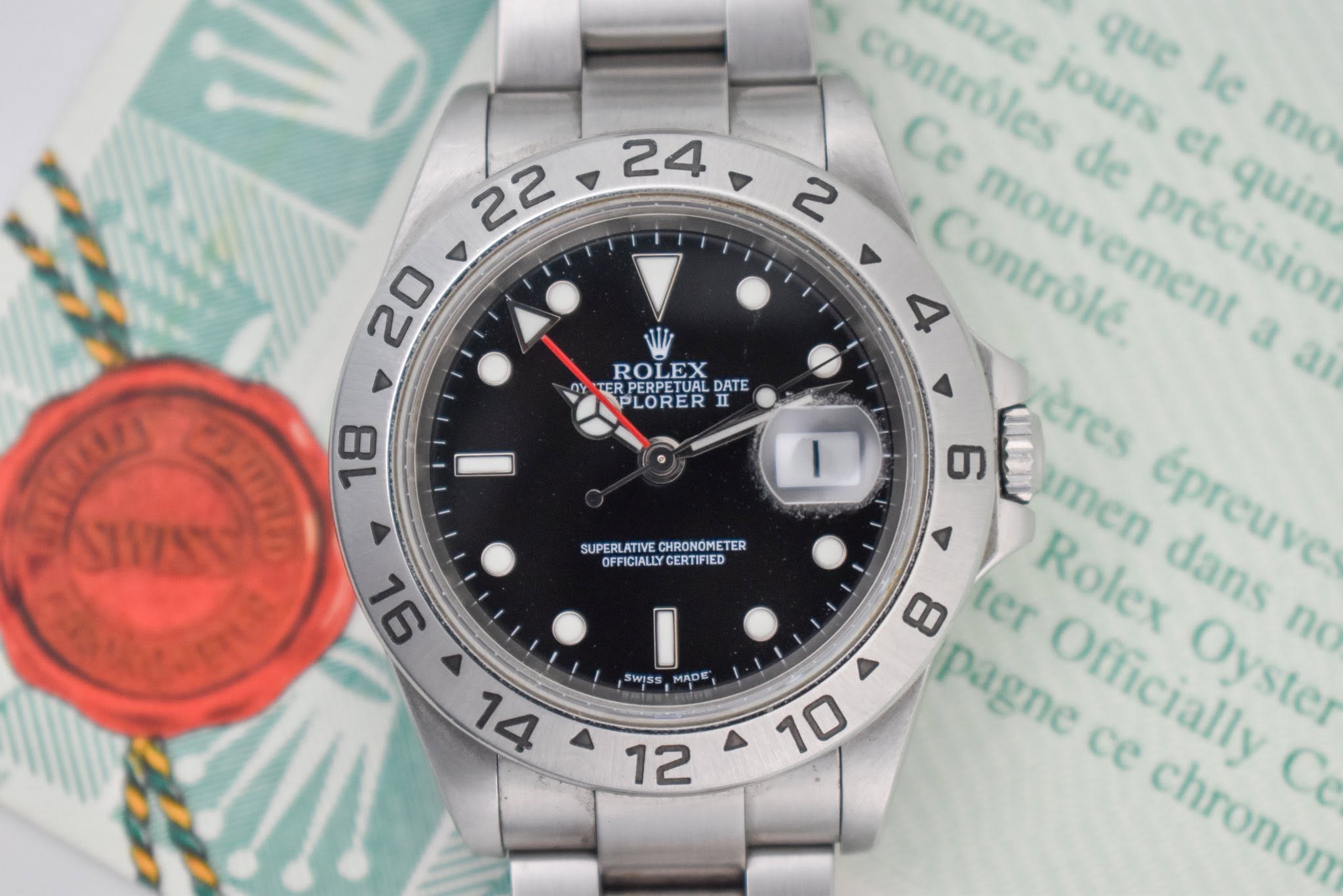 May be an image of wrist watch and text that says '24 22 20 ROLEX DY KERPERPETUALDATE TER DATE PLORER II 18 I SUPERU CHRONOMETE TER OFFICIALLYCERTIFIED SUPERLATIVE.CIBONPNETER…