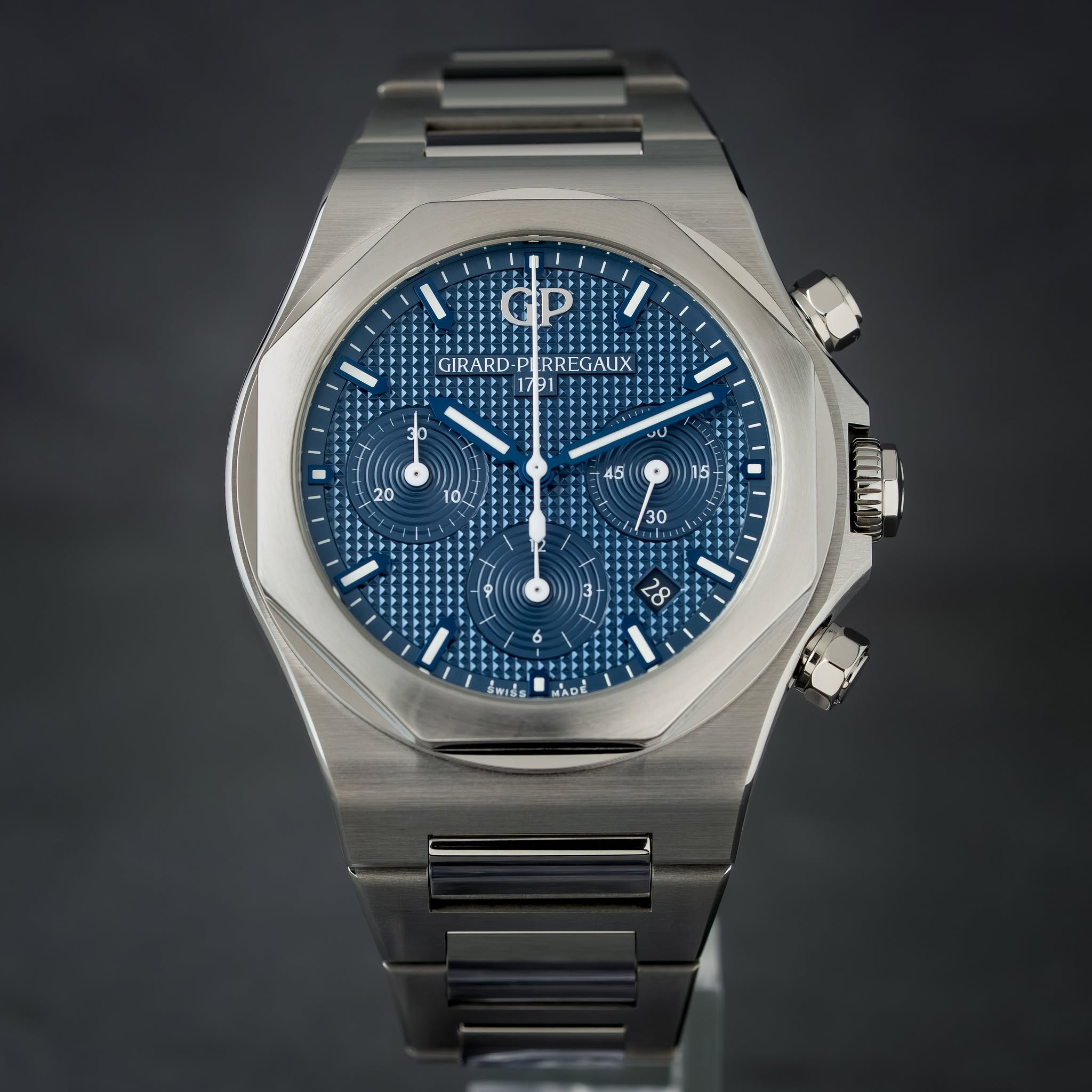 May be an image of wrist watch and text that says 'GIRARD- RREGAUX 1791 لاب 20 10/ 45 ร 30 MIII 26 MADE'