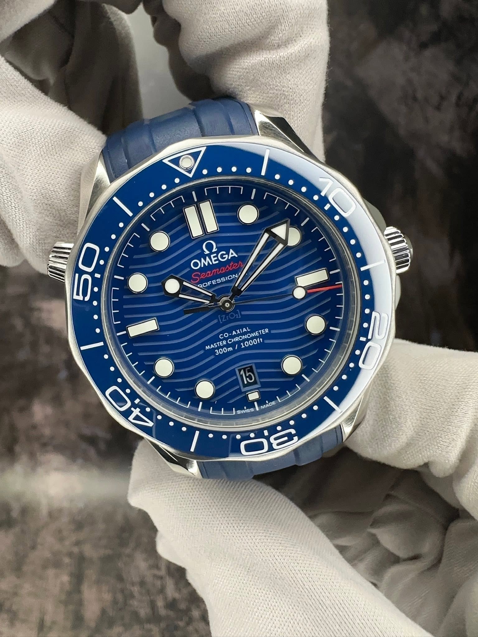 May be an image of wrist watch and text that says 'I 50 0 5 OMEGA ח ROFESSION G ROF ESSION CO CO O-AXIAL NRONOHE TER MASTER CRED 1000ft KRONOMETE 1000 300m 15 1 سلل ن ج ب Wss…