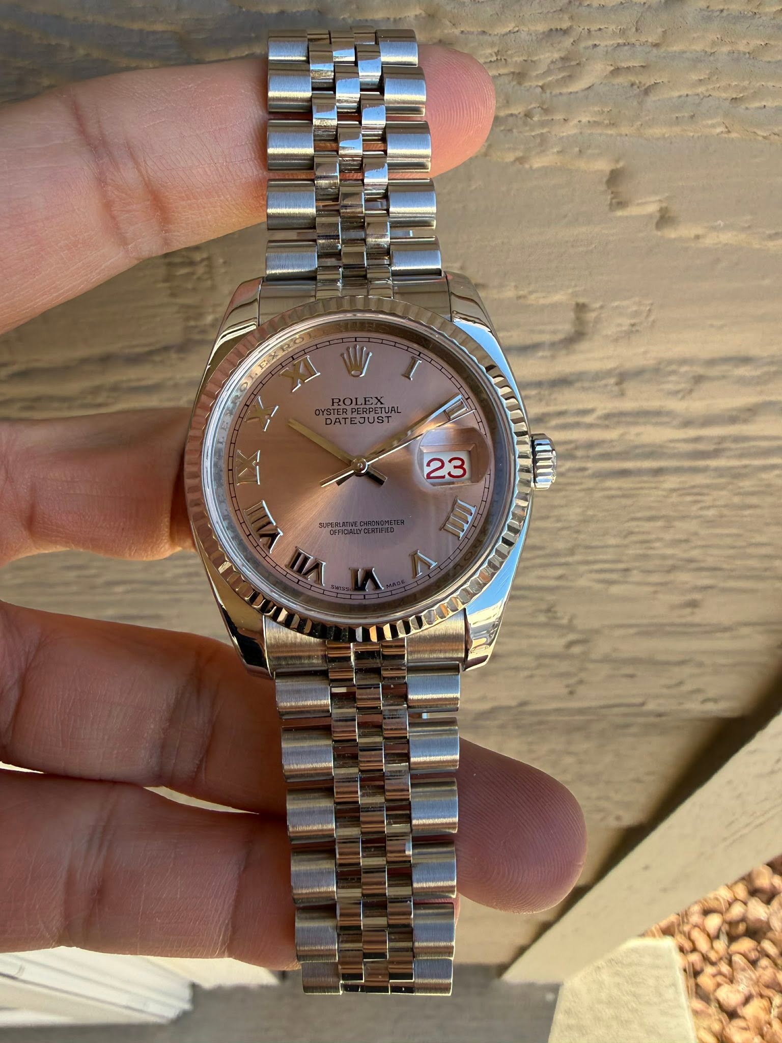 May be an image of wrist watch and text