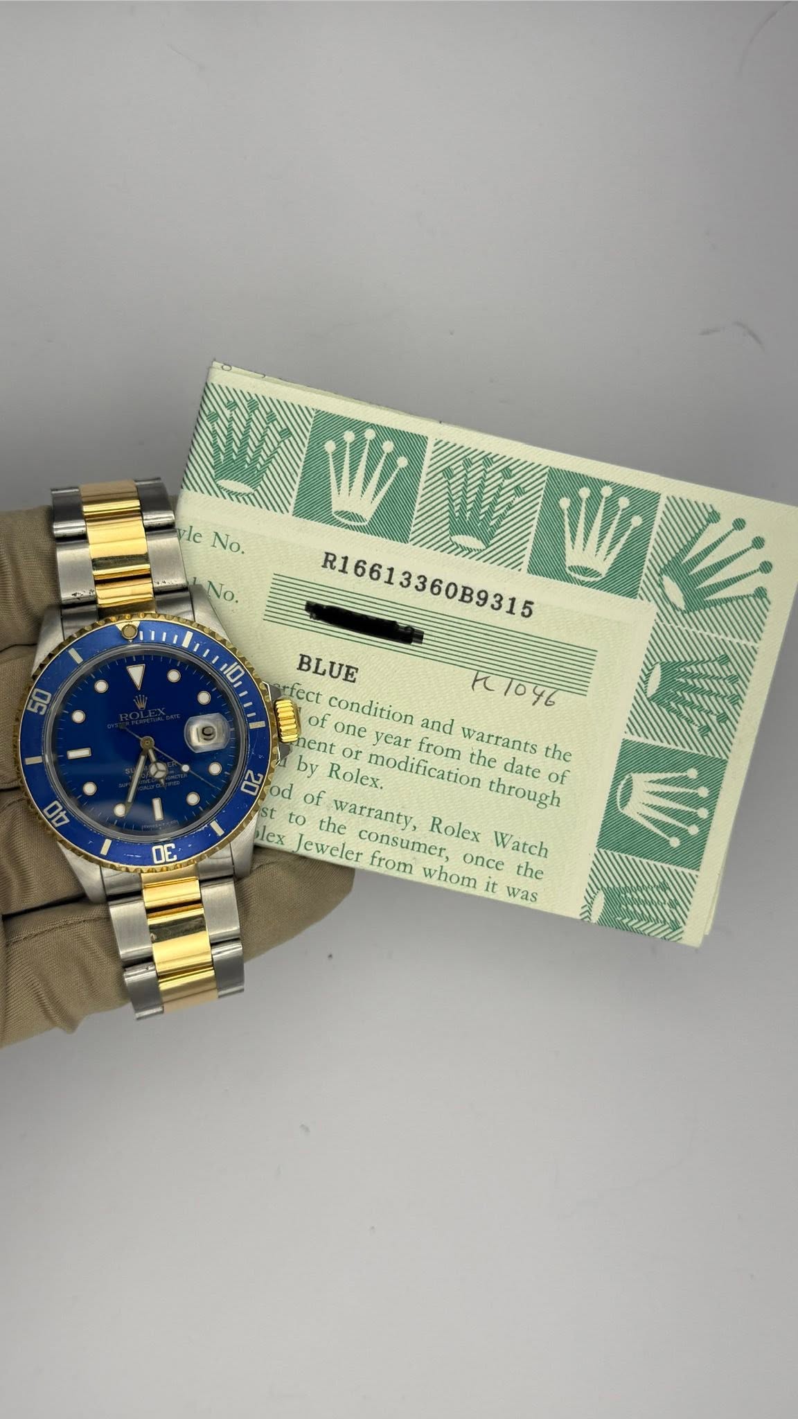 May be an image of digital watch and text that says '10 00 yle leNo. No. &No. WLW 15009 R16613360B9315 BLUE condition and 1/046 hent one year by Rolex. modification from warrants…
