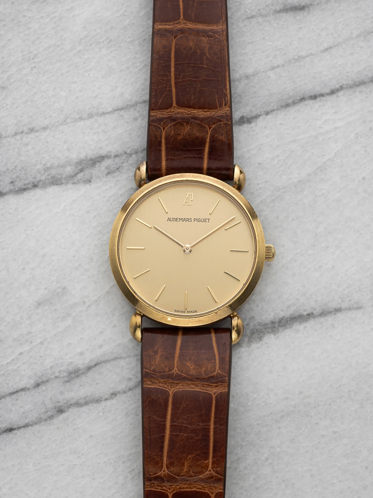 May be an image of leather, wrist watch and text