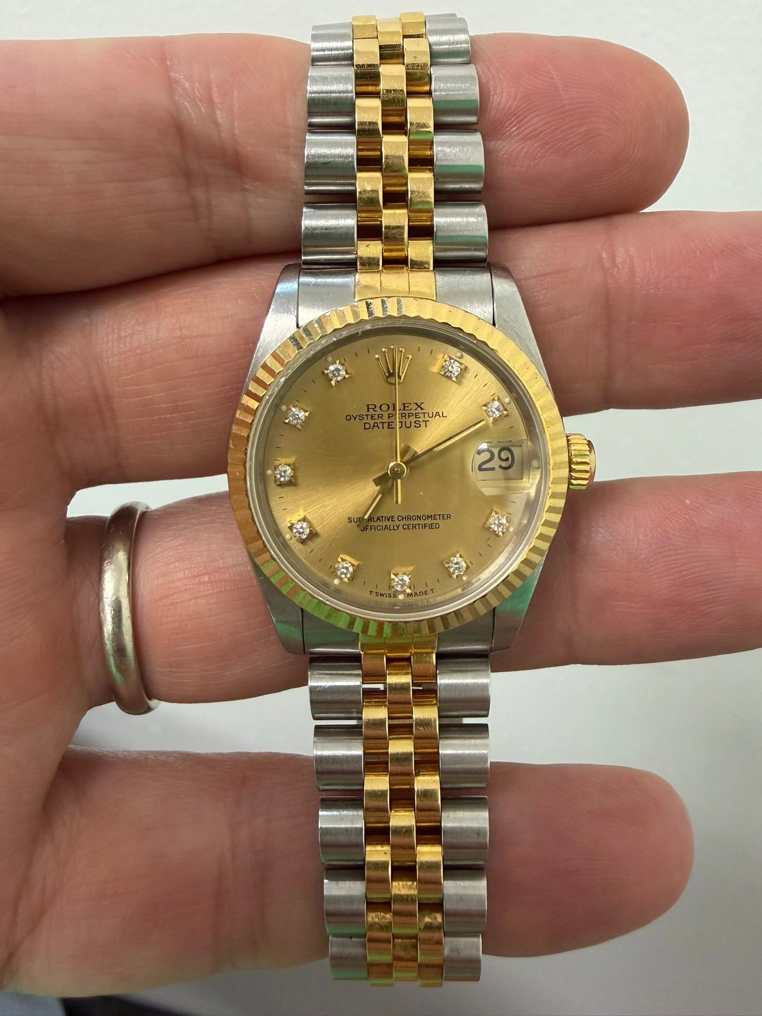 May be an image of wrist watch and text