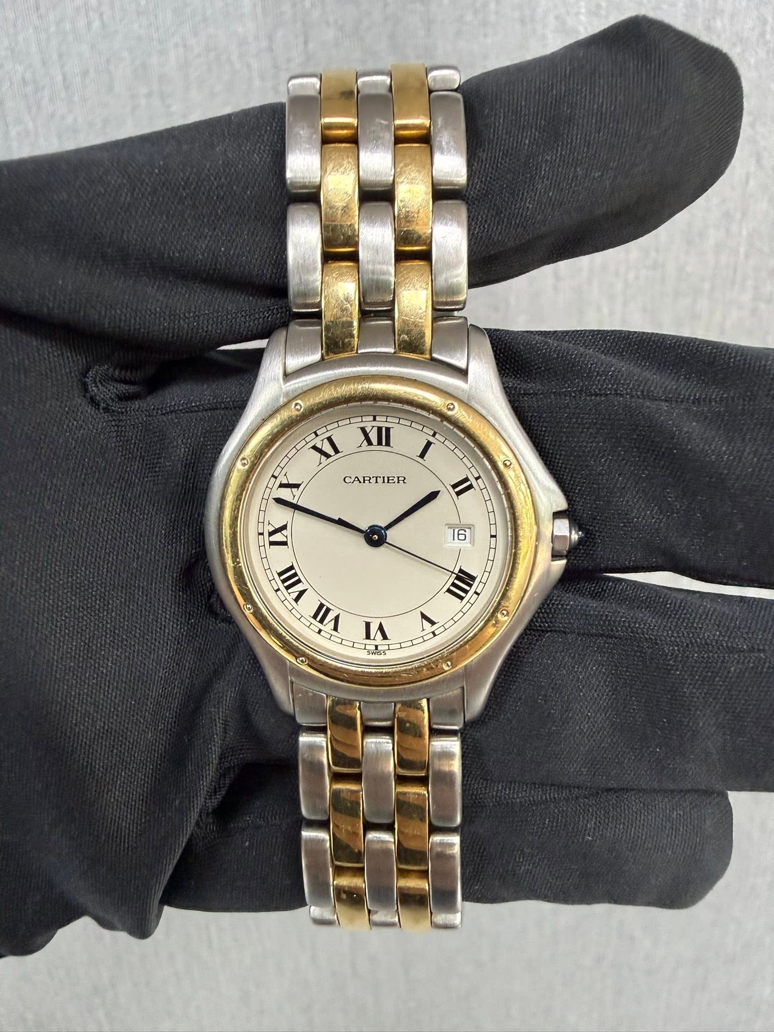 May be an image of wrist watch and text that says '۵ မ O CCS ១ XI XII X CARTIER IX VIII VII VI 0 II II 16 6 III 10'