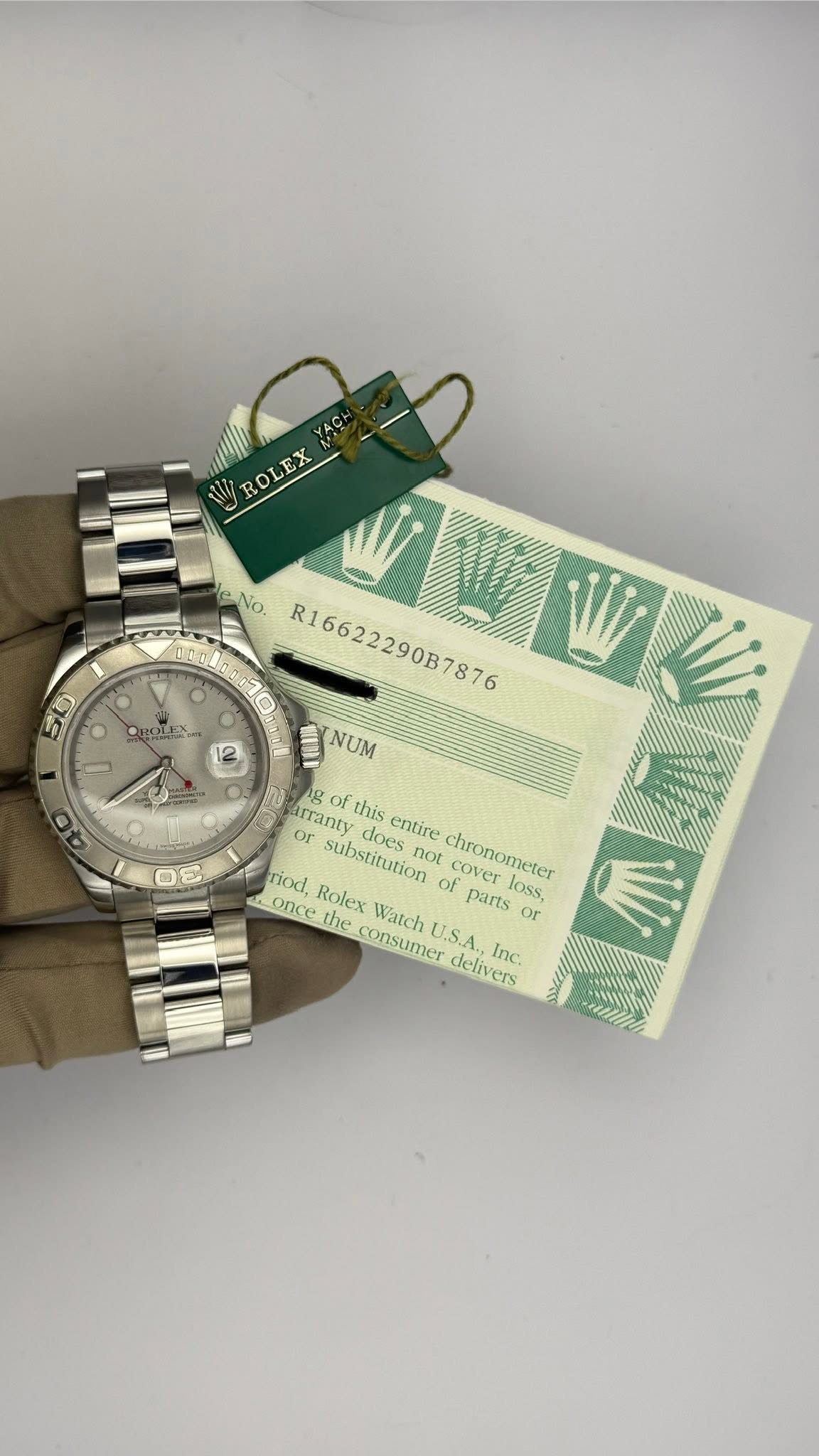 May be an image of wrist watch and text that says 'ROLEX RD ROtEN 50 - 12 leNo. R16622290B7876 JNUM NUM g or arranty o of this entire riod, Rolex Watch substitution of cover loss.…